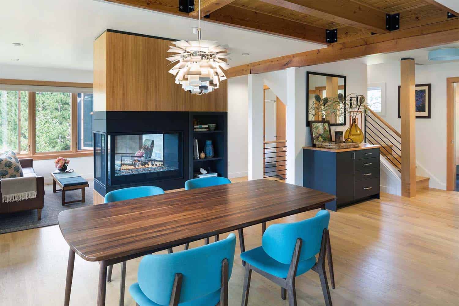 midcentury modern dining room with a dual-sided fireplace