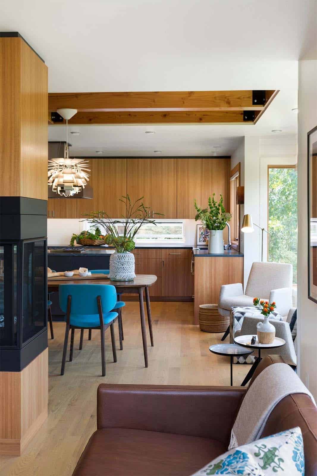midcentury modern kitchen and dining room with a dual-sided fireplace