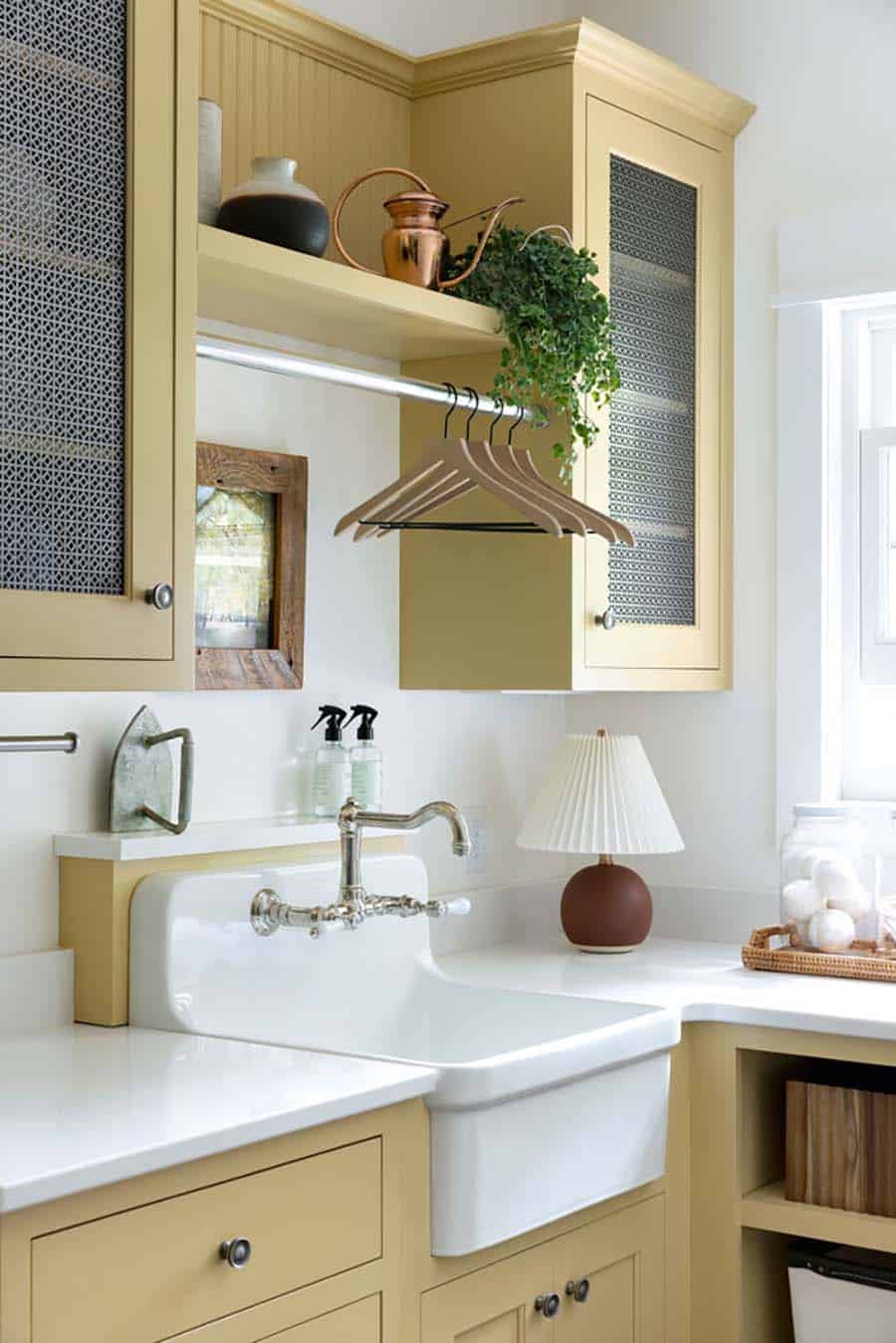 contemporary laundry room with yellow cabinets