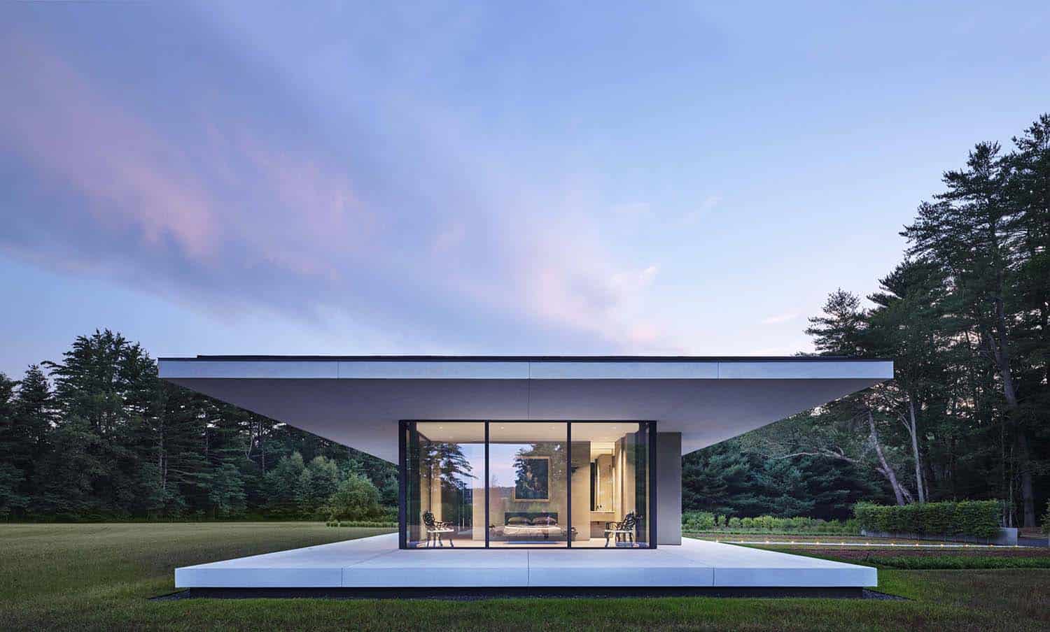 minimalist glass house exterior at dusk
