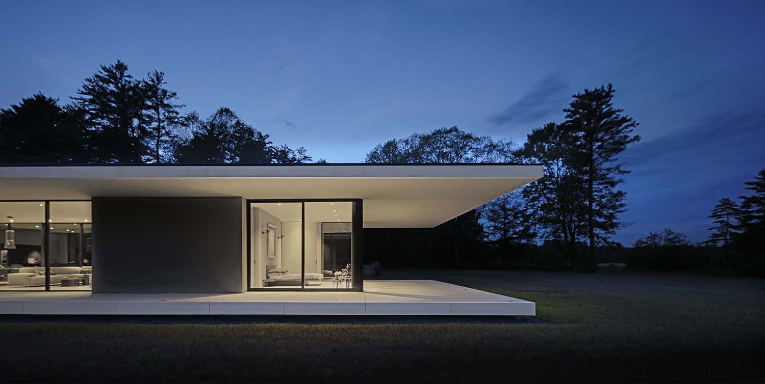 minimalist glass house exterior at dusk