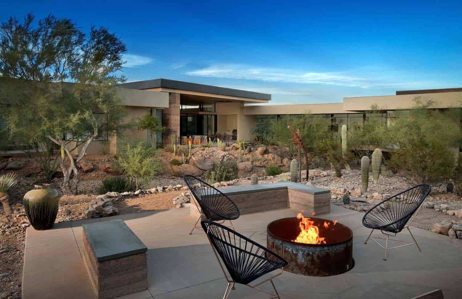 modern home exterior with a patio and fire pit