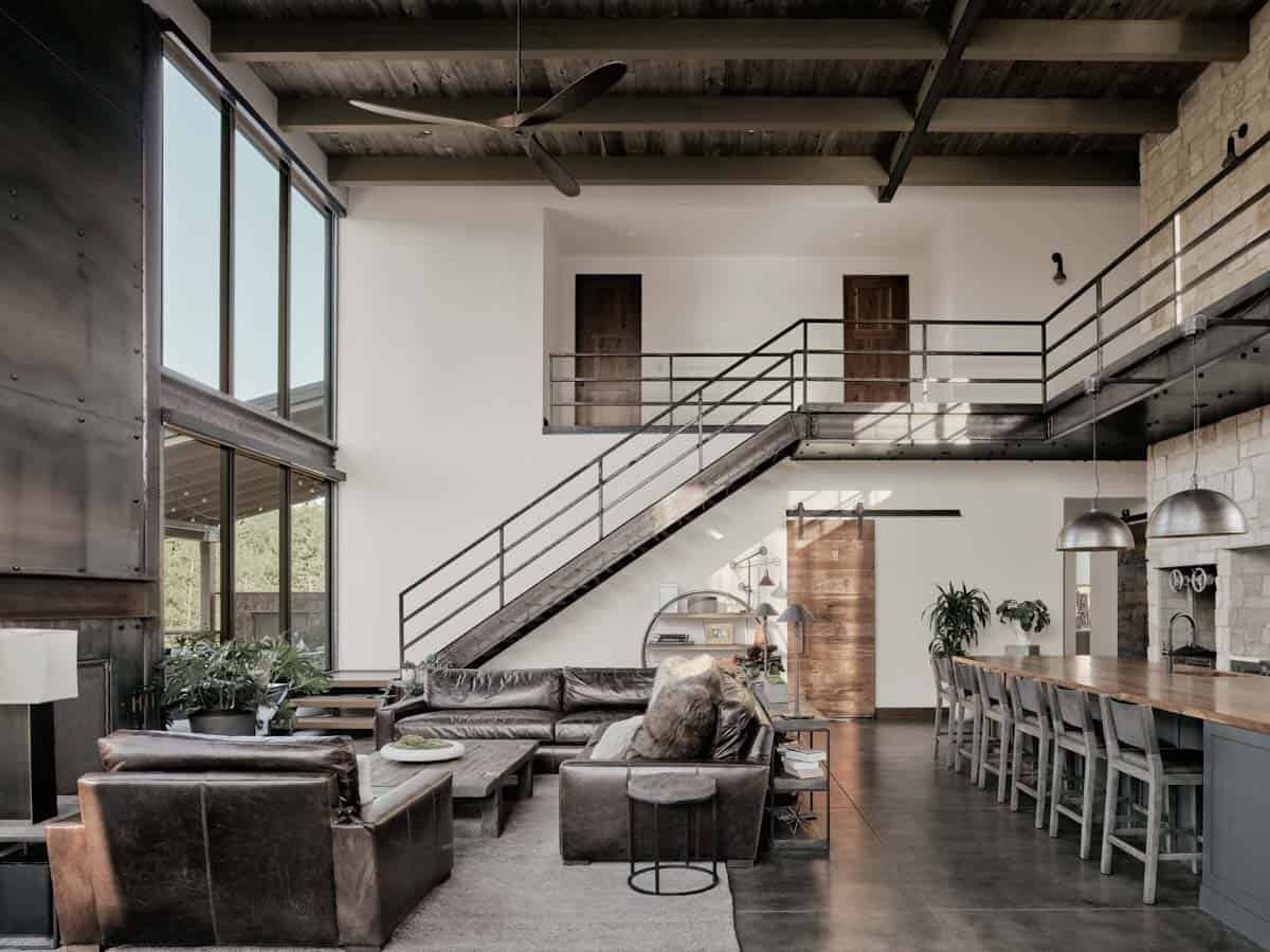 modern great room with a steel staircase