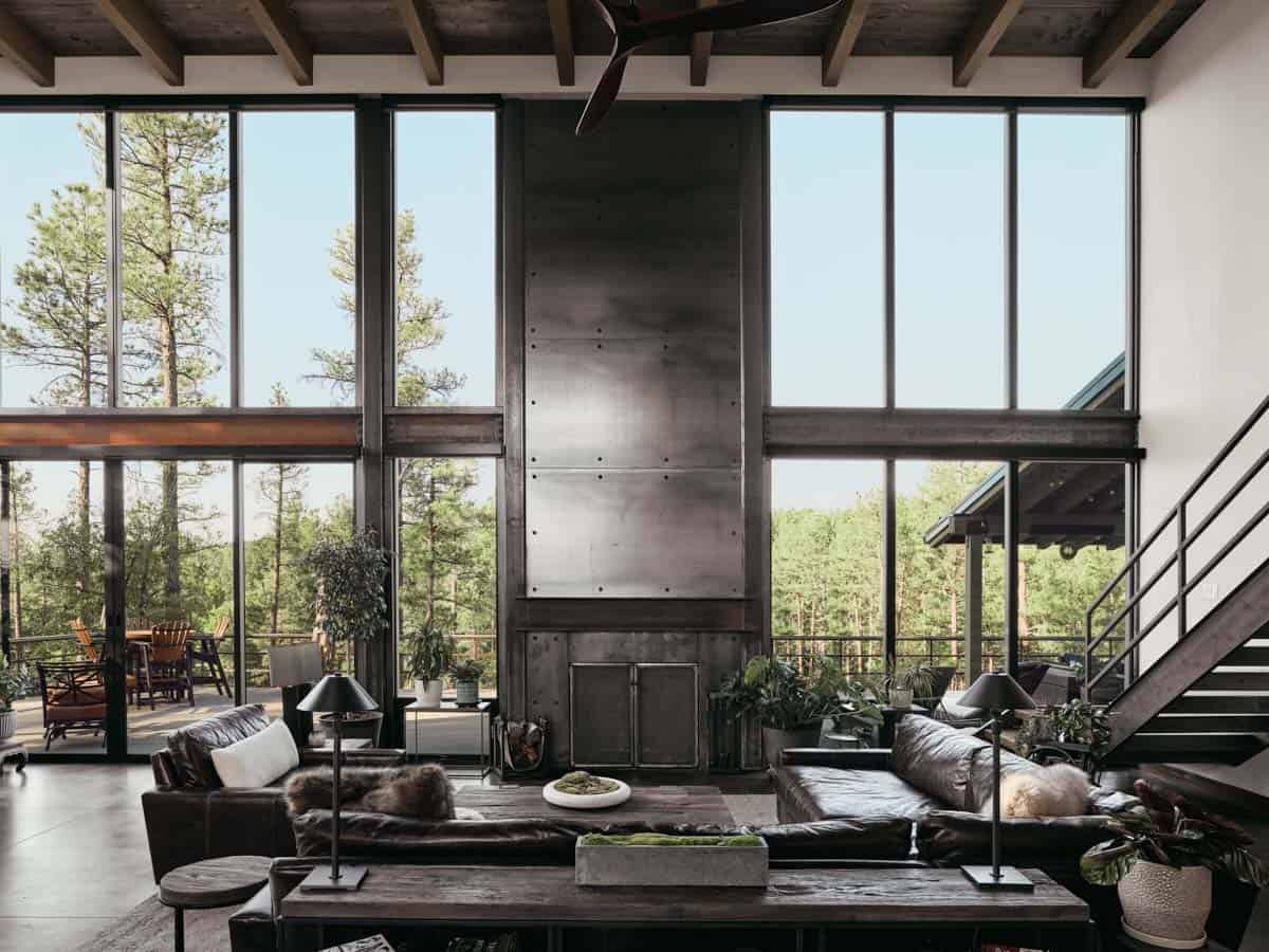 modern living room with a steel-clad fireplace and large windows