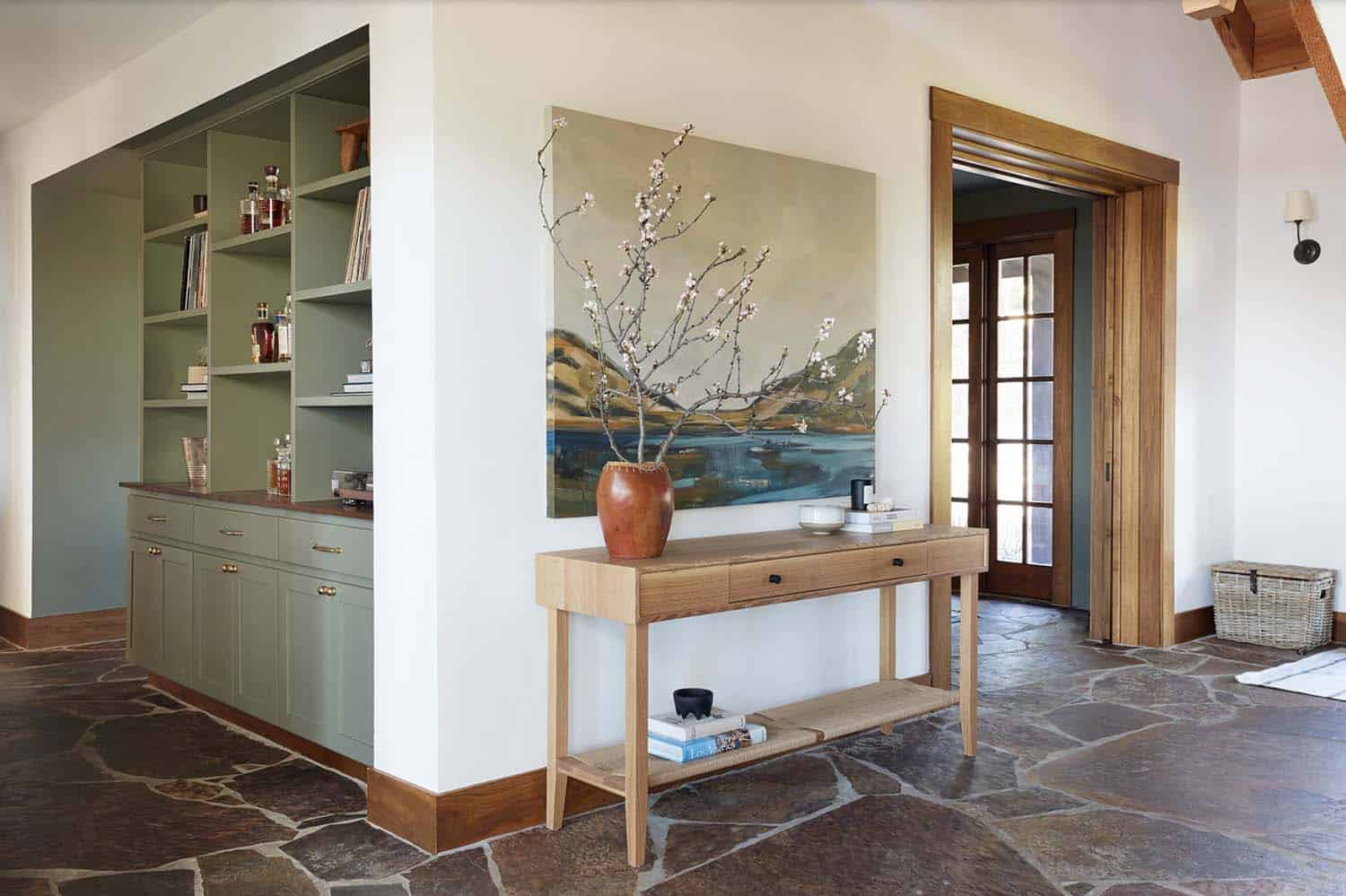 modern rustic mountain home entry with a console table and artwork