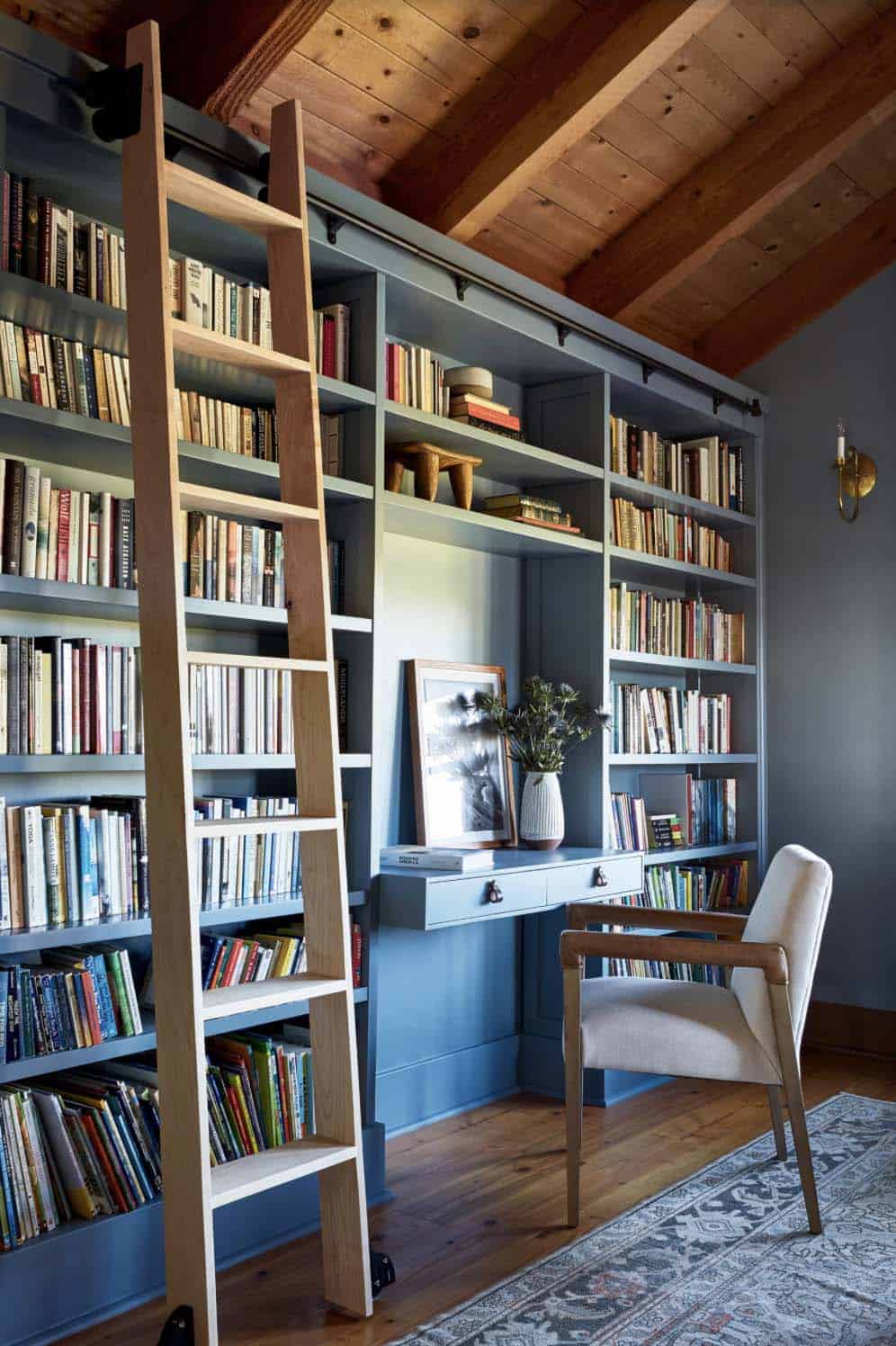modern rustic home library with a desk and rolling ladder