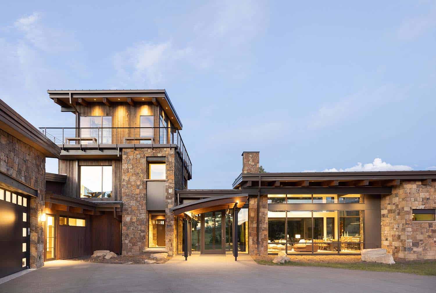 modern rustic ranch house exterior at dusk