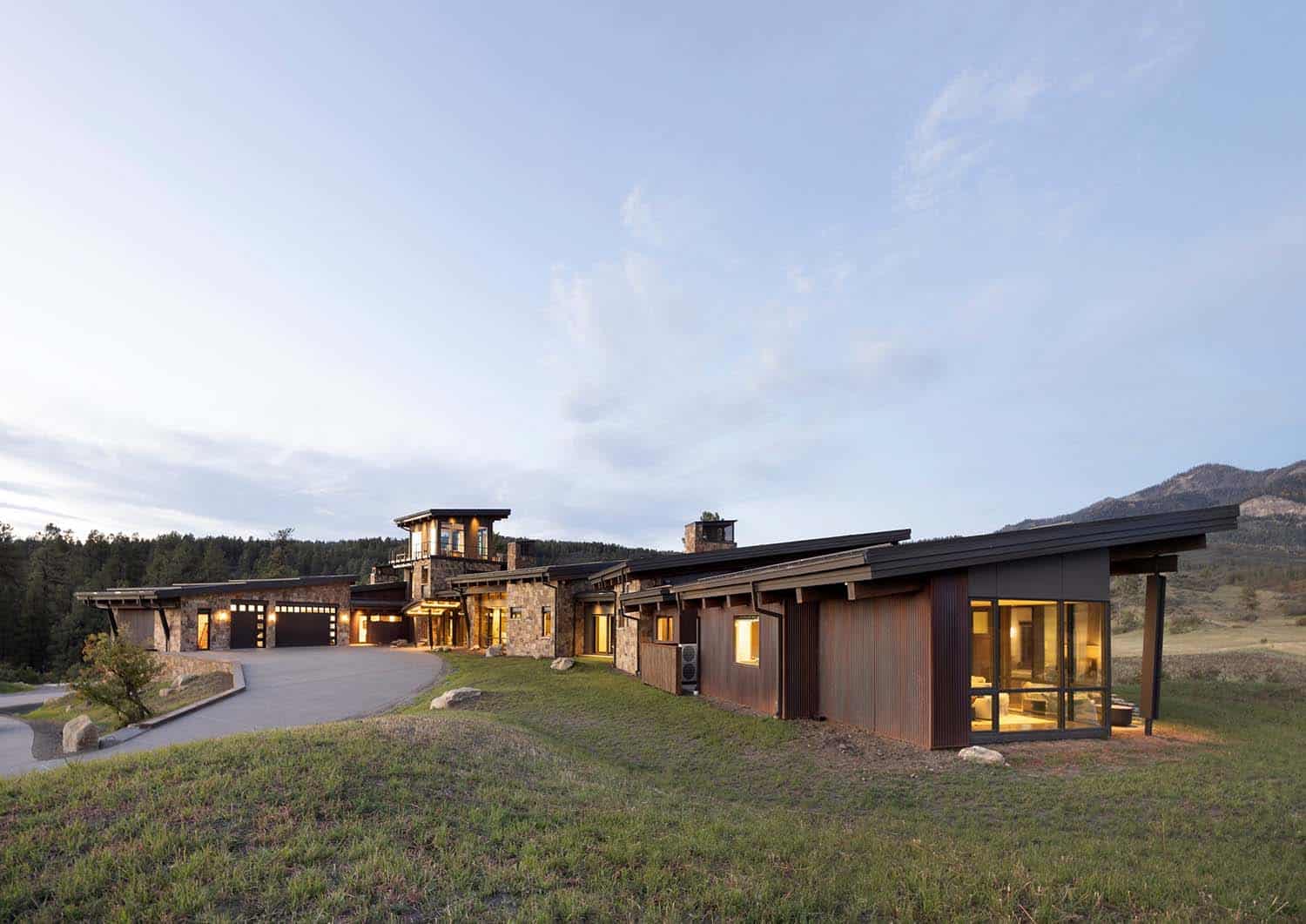 modern rustic ranch house exterior at dusk