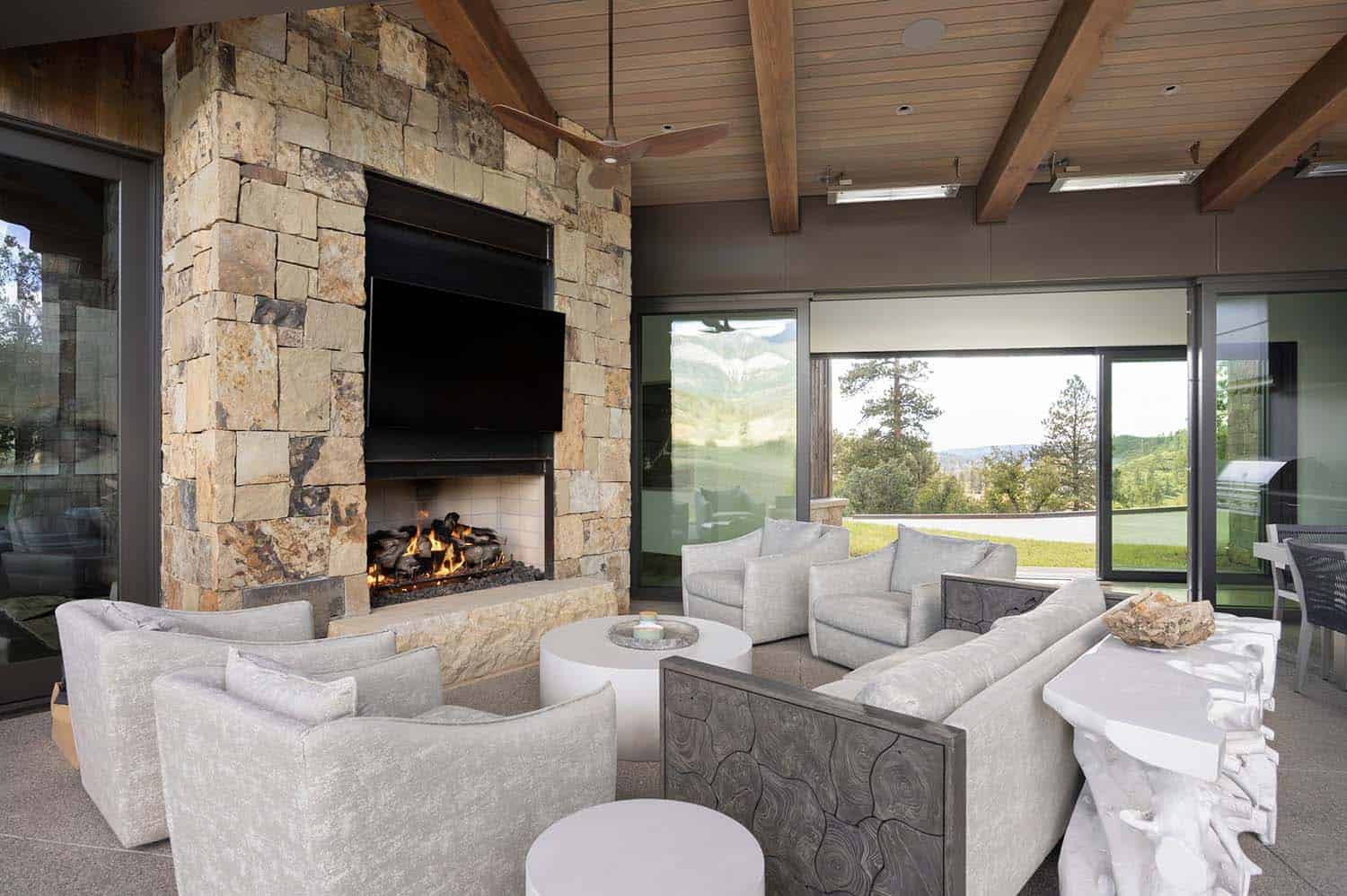 modern covered porch with a fireplace