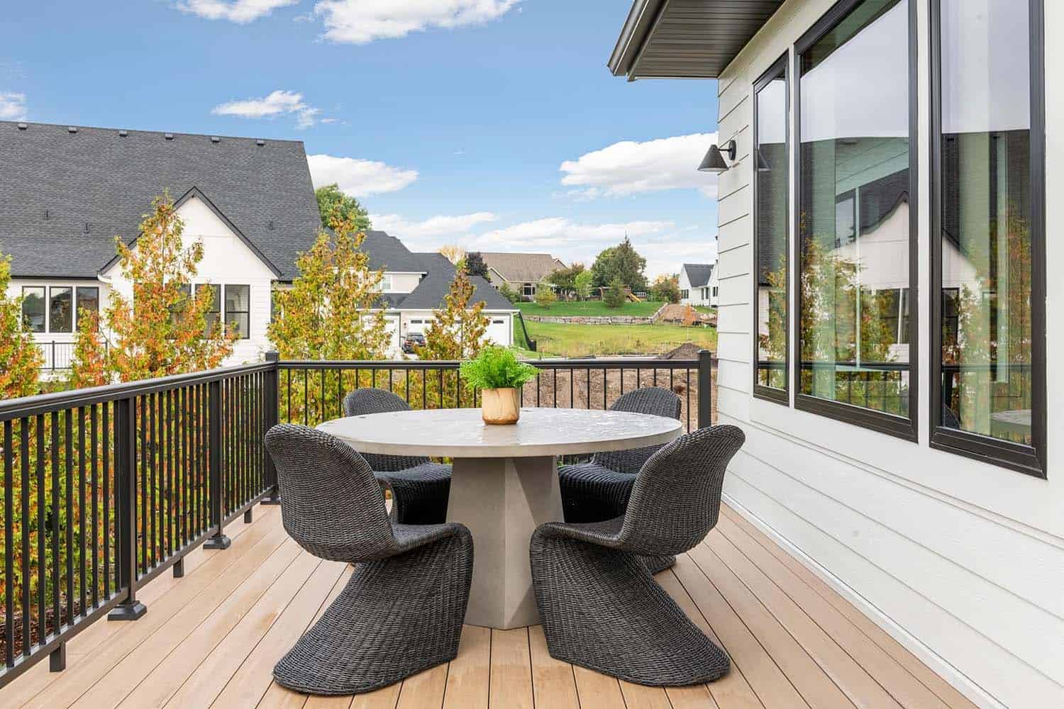 modern backyard deck with an outdoor dining table