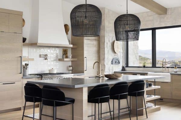 modern mountain style kitchen with large pendant lights