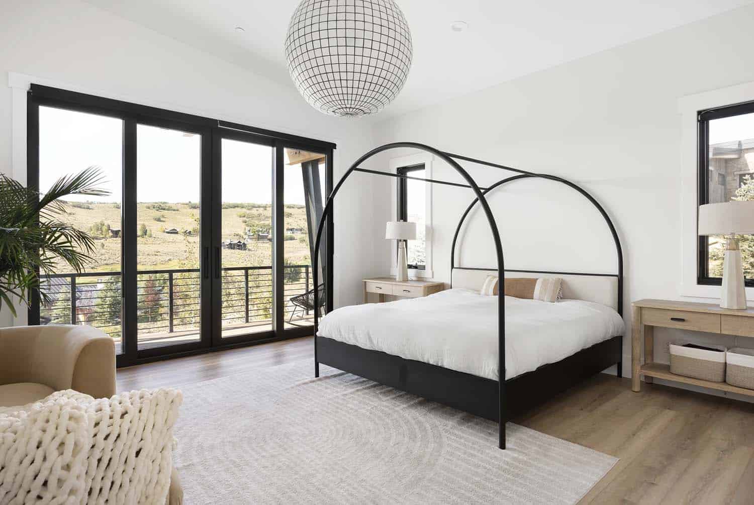 modern bedroom with a canopy bed and private balcony