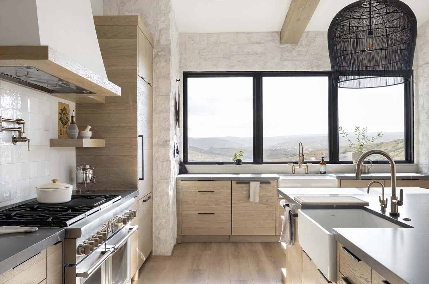 modern kitchen with a large window and mountain views