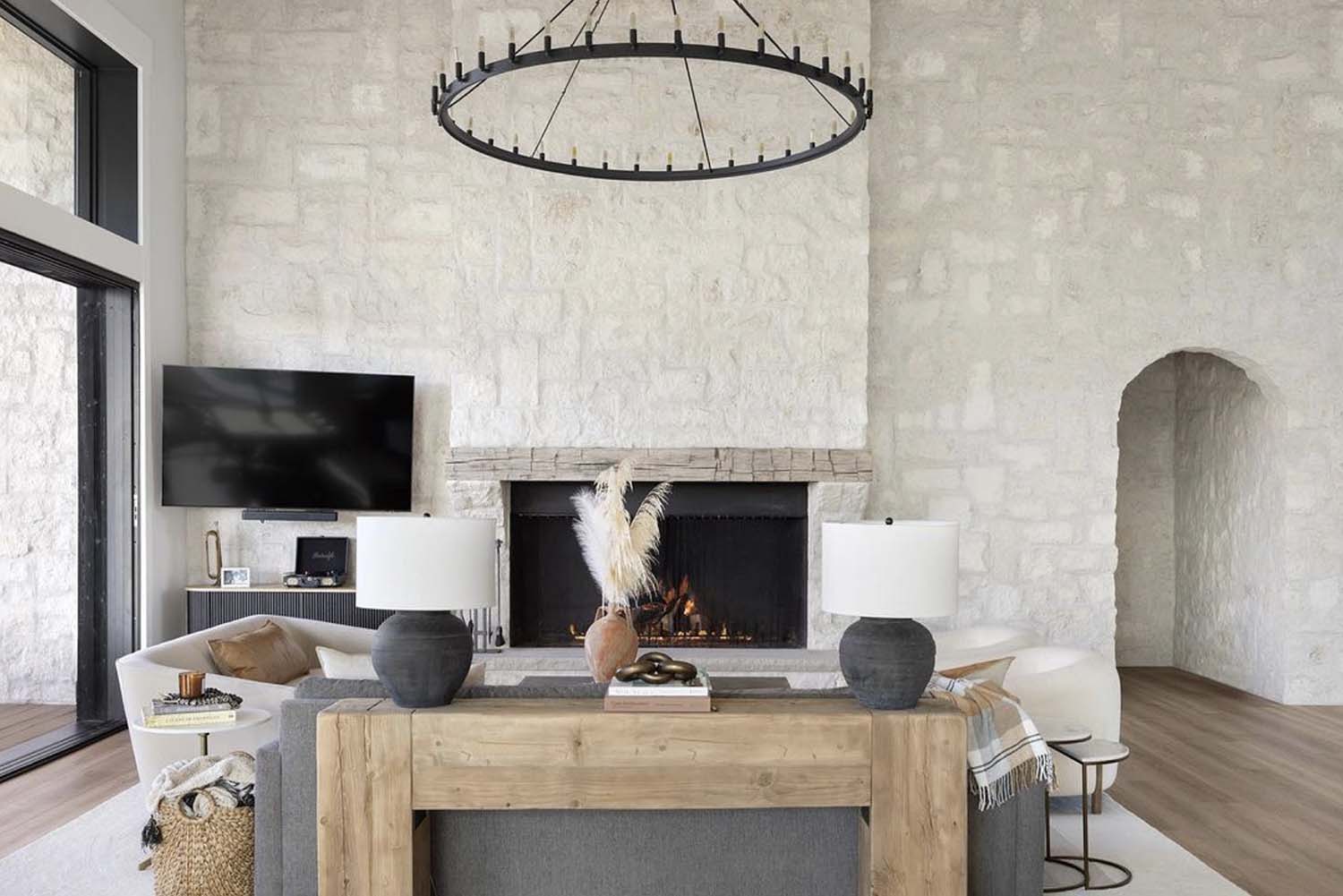 modern living room with a fireplace and limestone wall