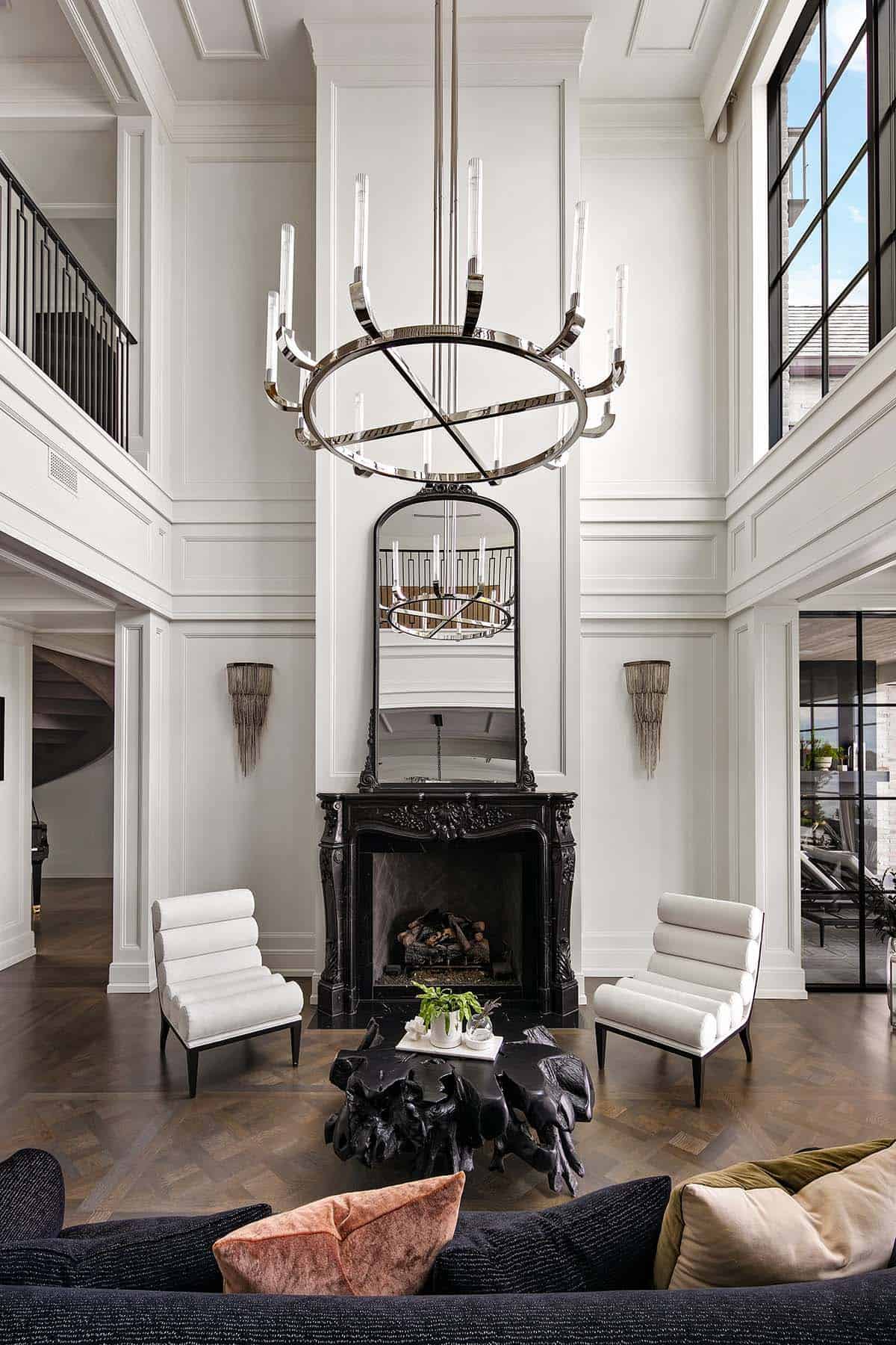 transitional style double volume living room with a fireplace