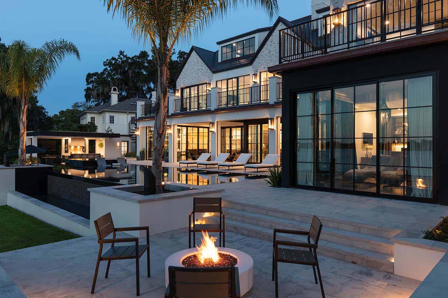 transitional style home exterior backyard patio with a fire pit