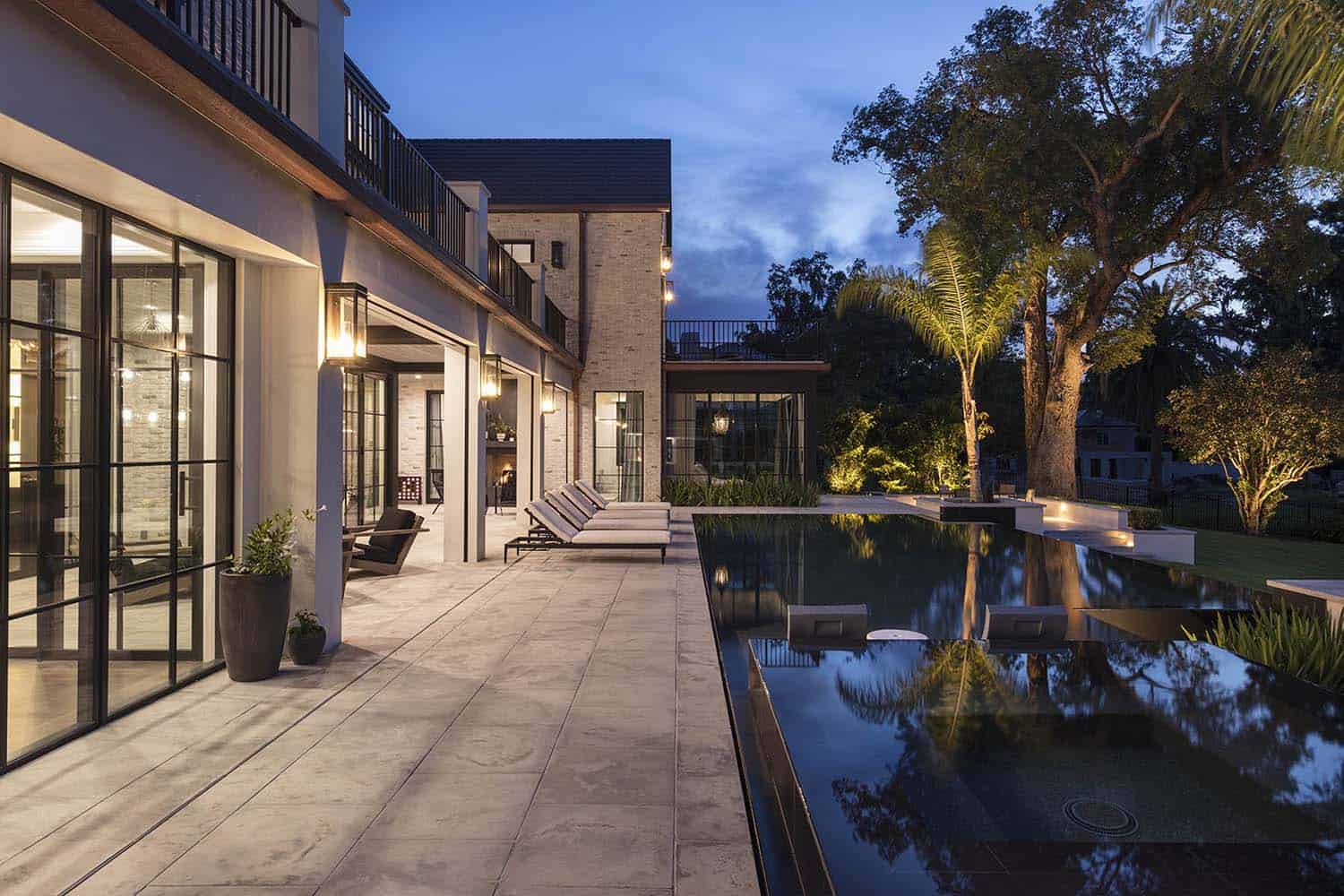transitional style home backyard patio exterior at dusk