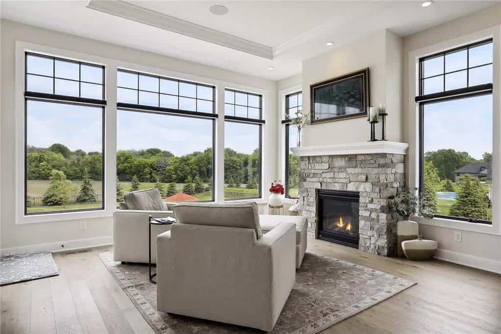 transitional style sunroom with a fireplace