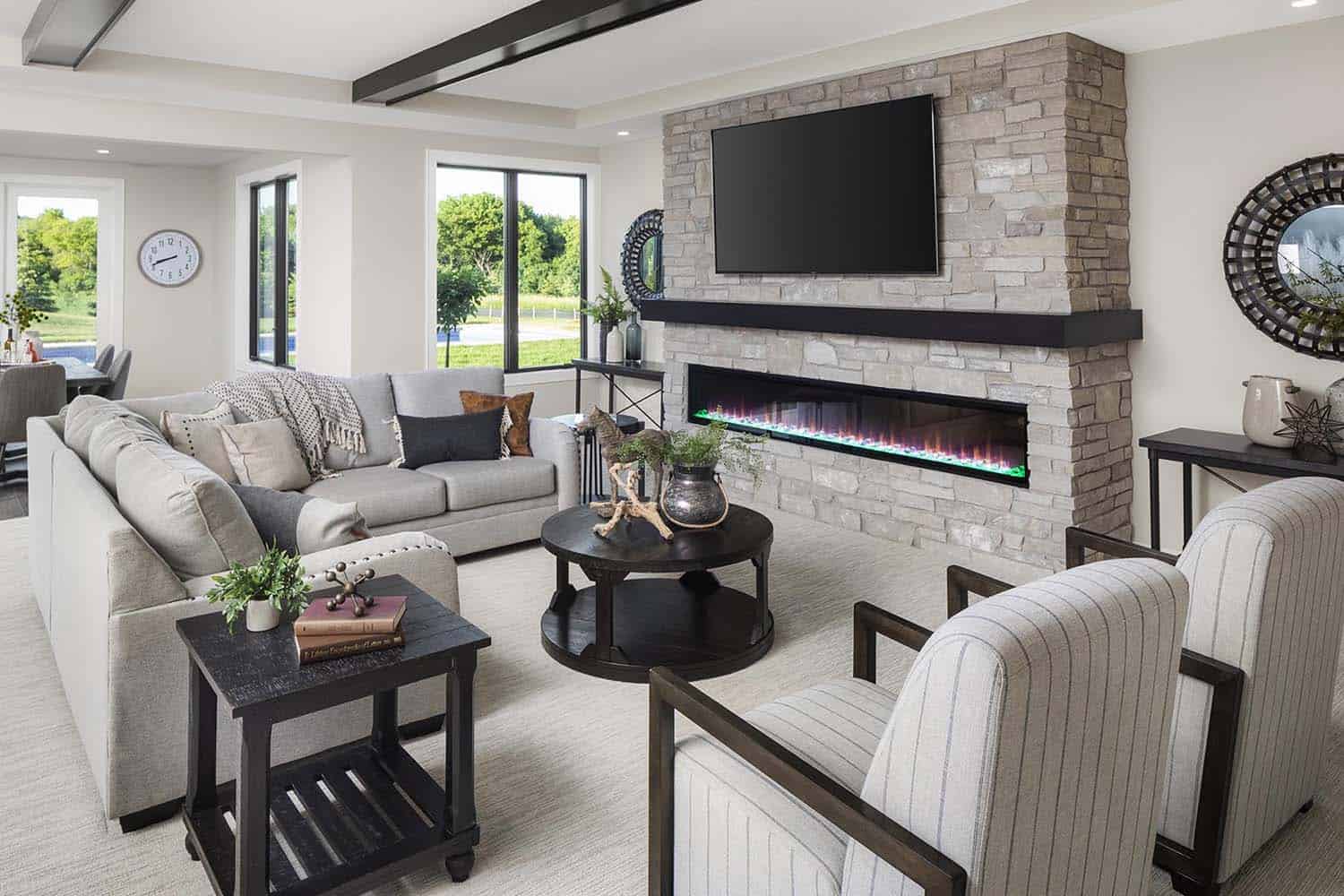 transitional style family room with a fireplace