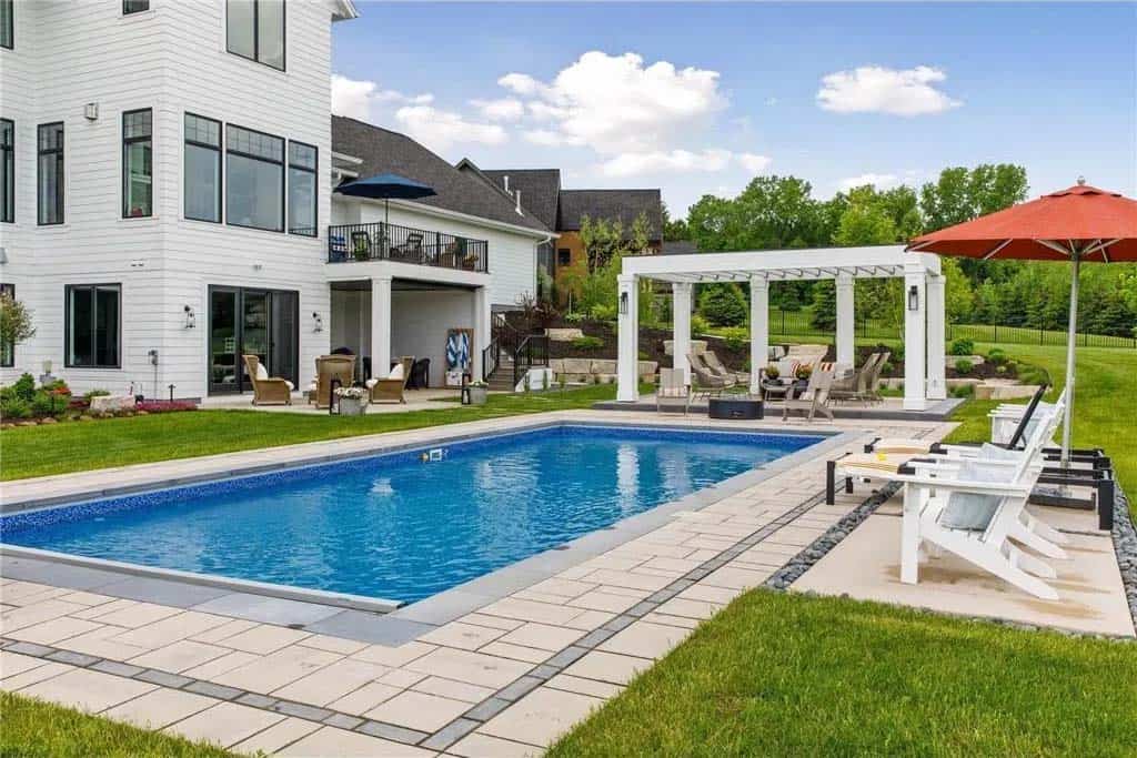 transitional style home exterior backyard with a pool 