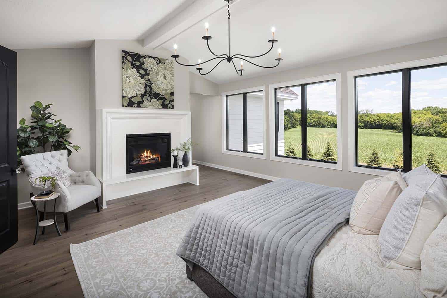 transitional style bedroom with a fireplace