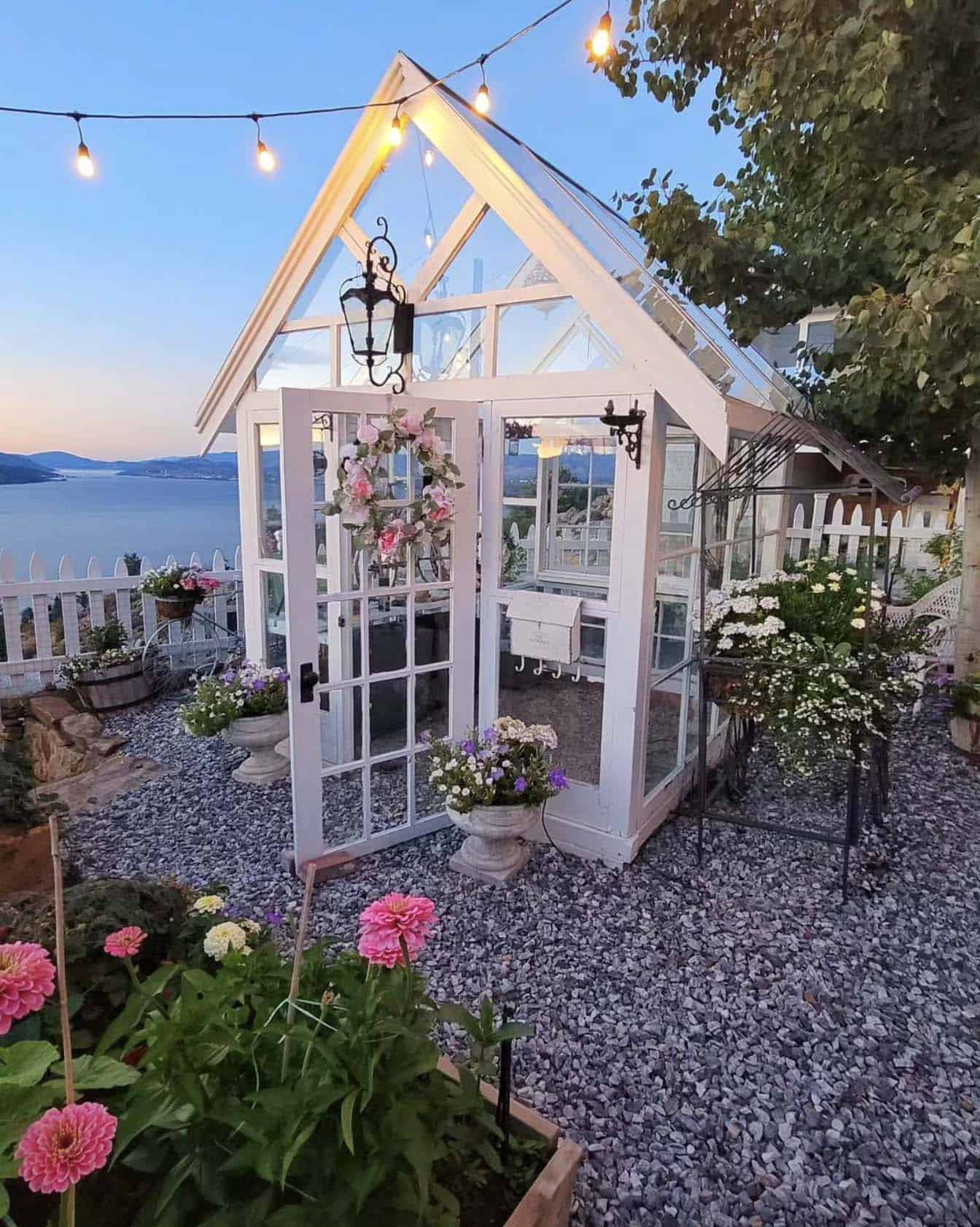 she shed greenhouse with a pink wreath and vintage mailbox