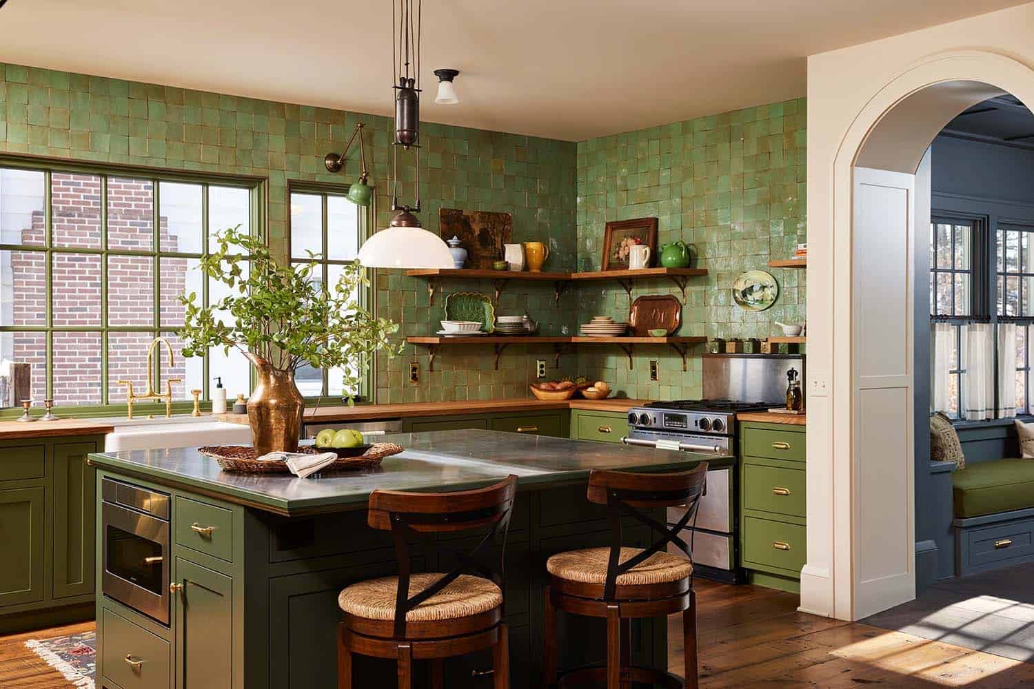 transitional island kitchen with green tiles and wood countertops