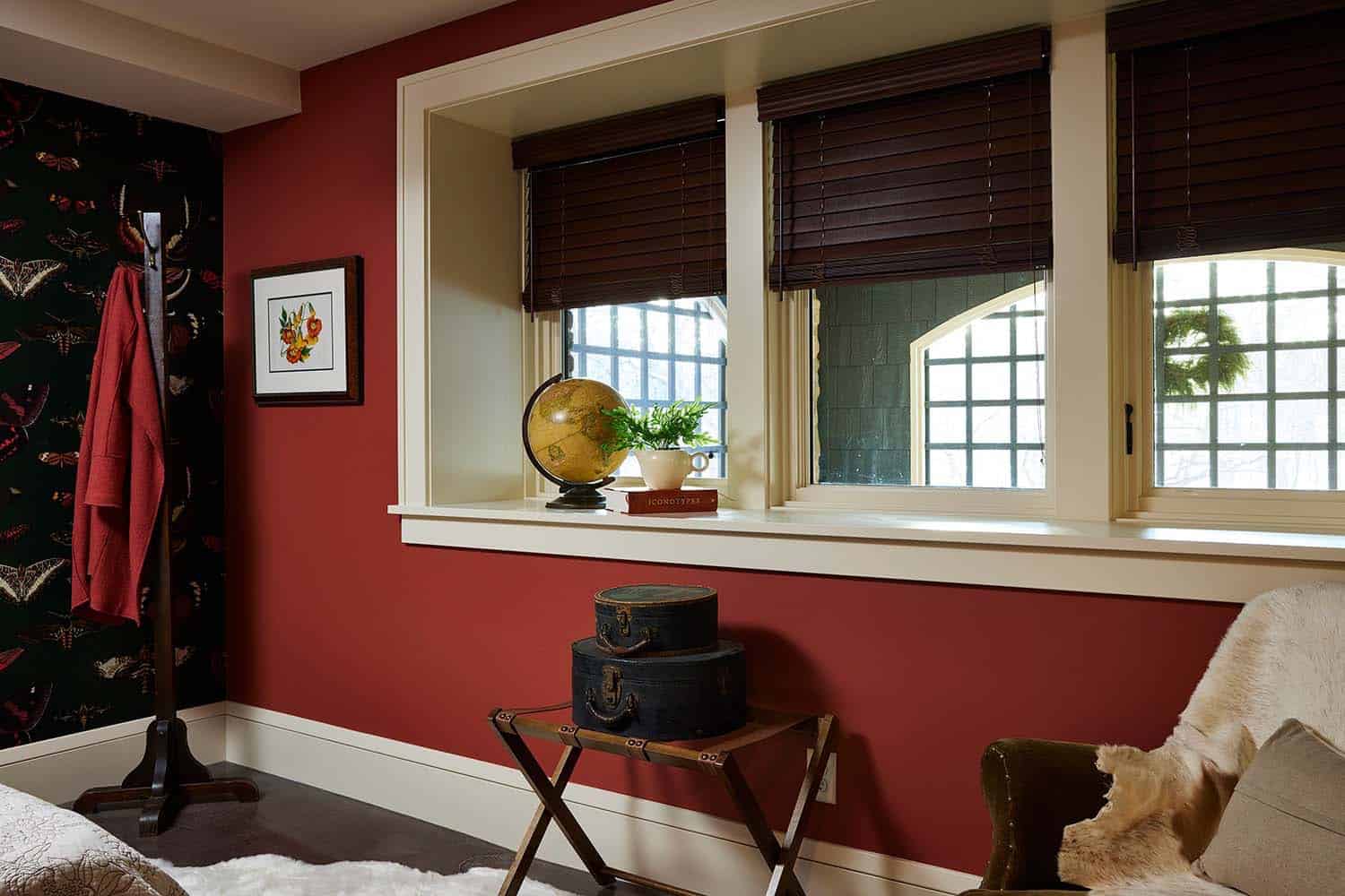 transitional guest bedroom with red painted walls