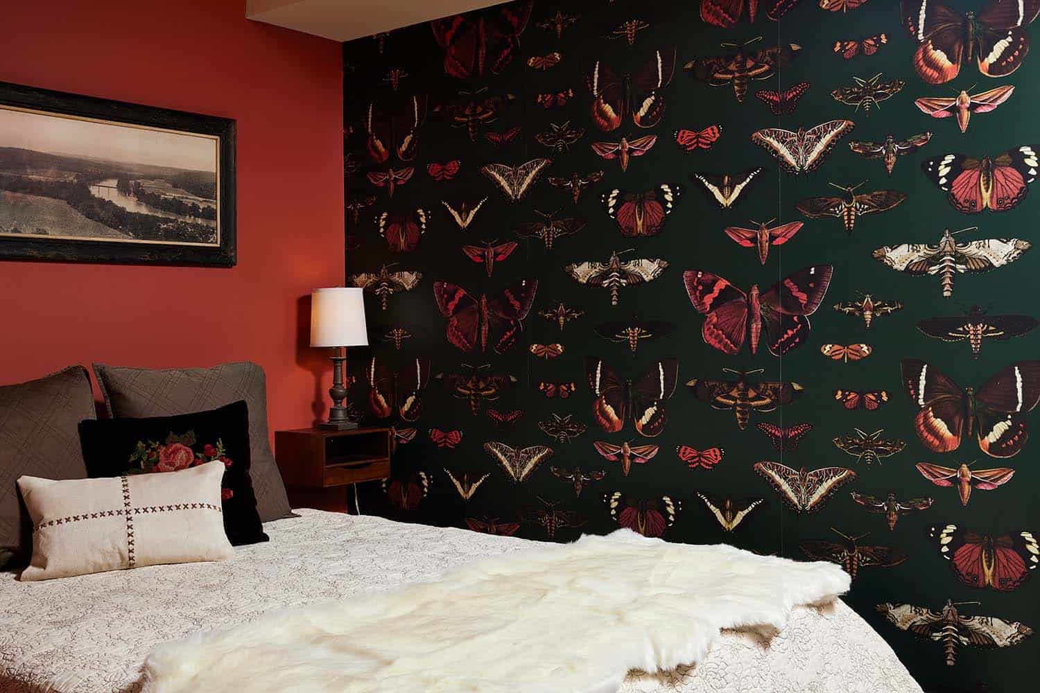 transitional guest bedroom with butterfly wallpaper