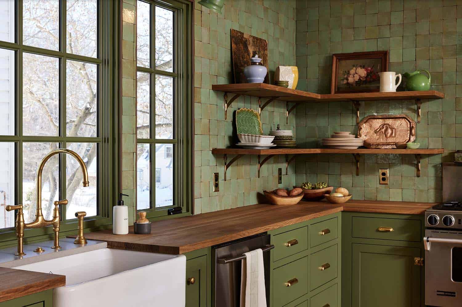 transitional kitchen with green tiles and wood countertops