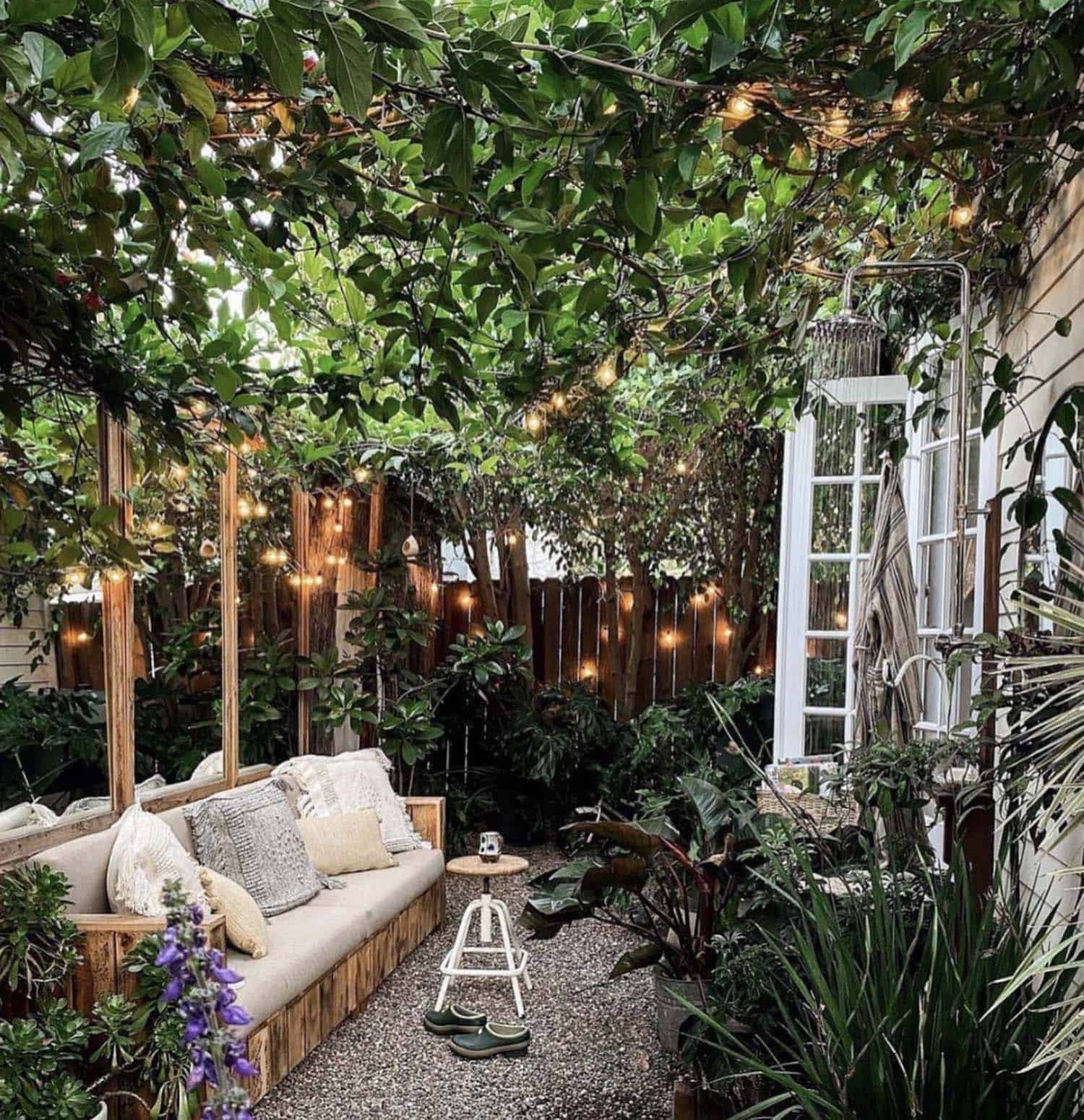 side yard patio with vines, outdoor furniture and an outdoor shower