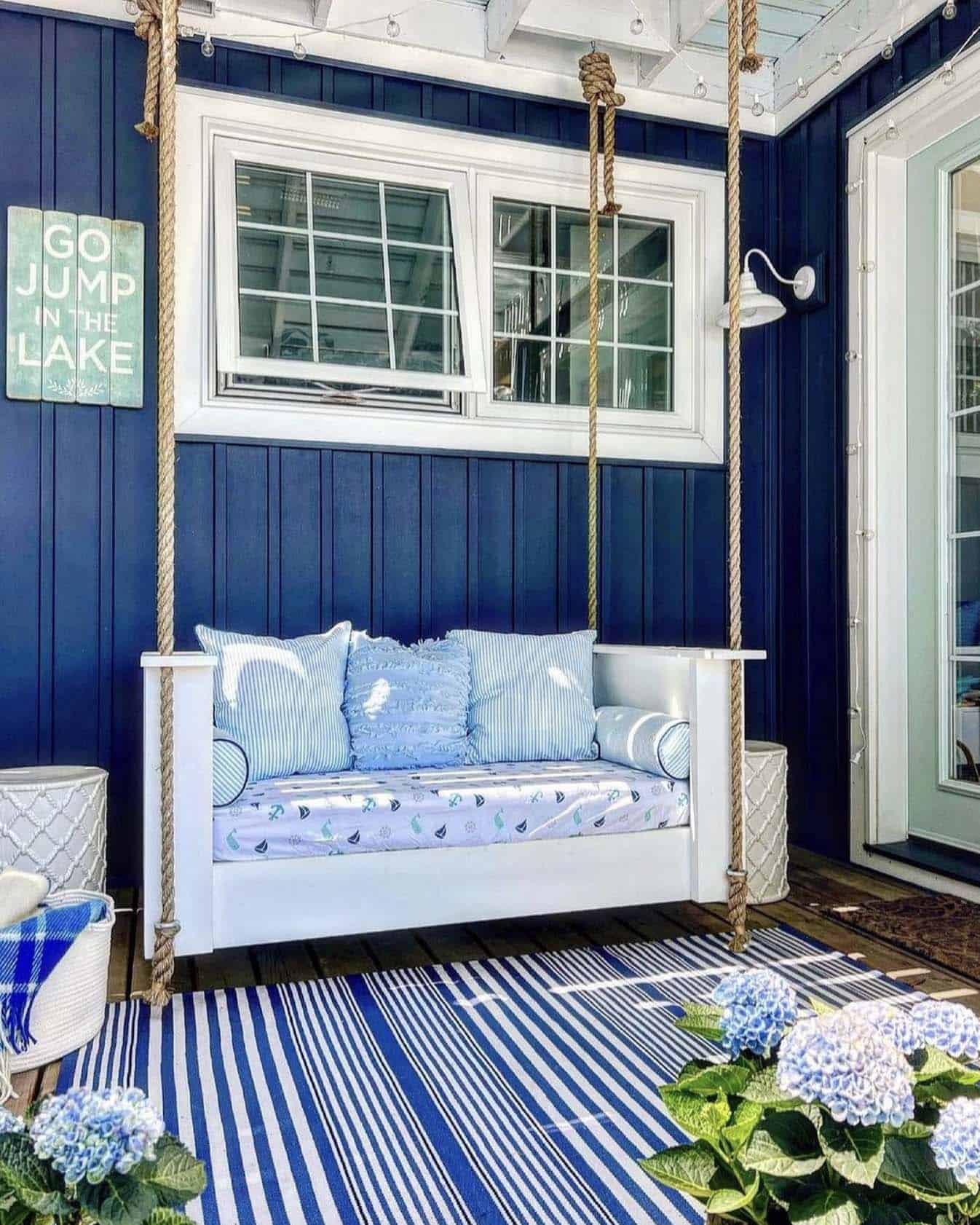 front porch with a hanging swing and nautical accents