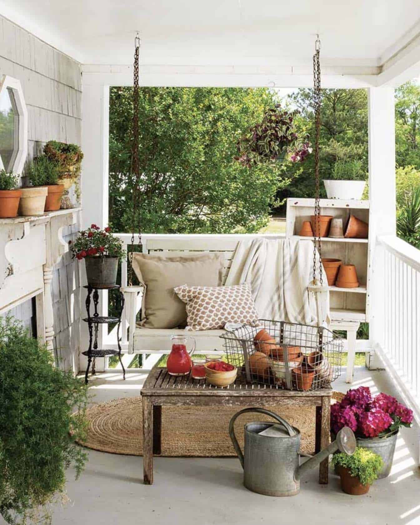 dreamy porch setting with a hanging swing and potted plants