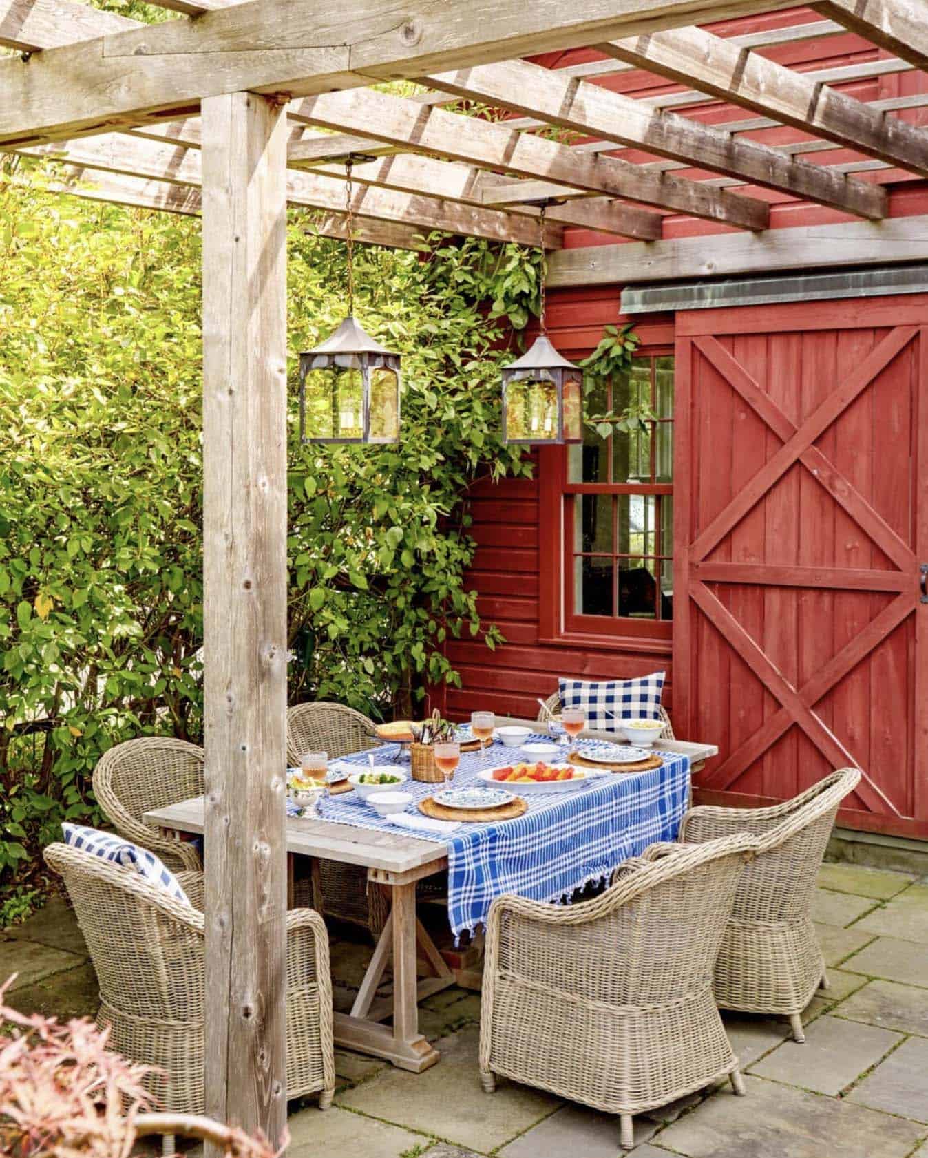 outdoor dining on the patio with a trellis and hanging lanterns