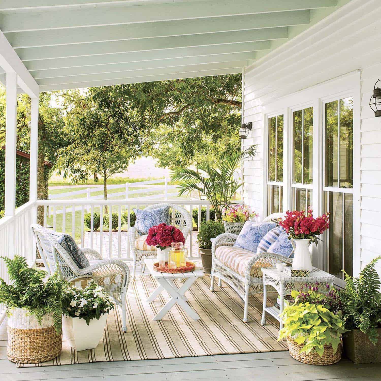 front porch with a haint blue ceiling and wicker furniture