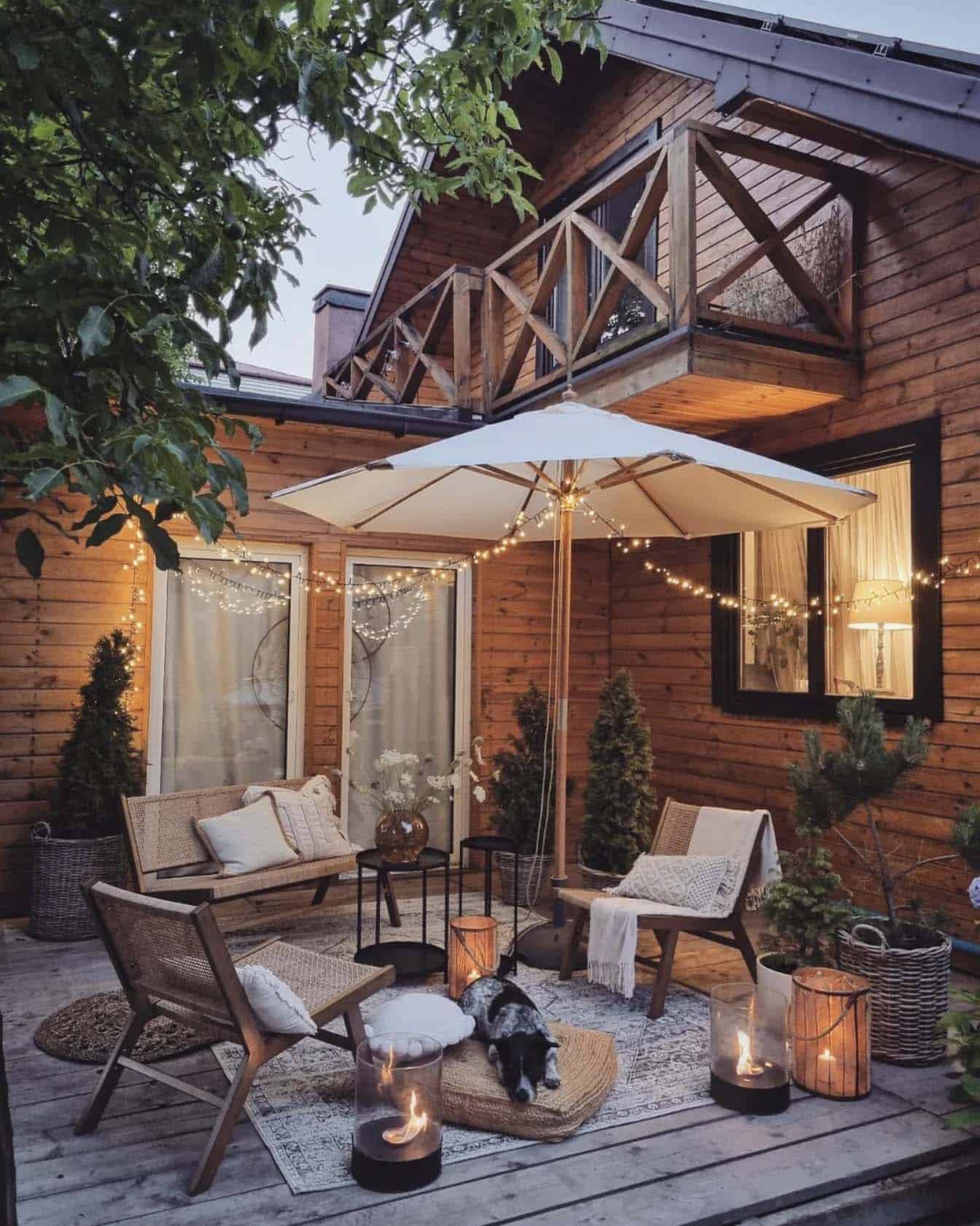 boho style patio with an umbrella and string lights