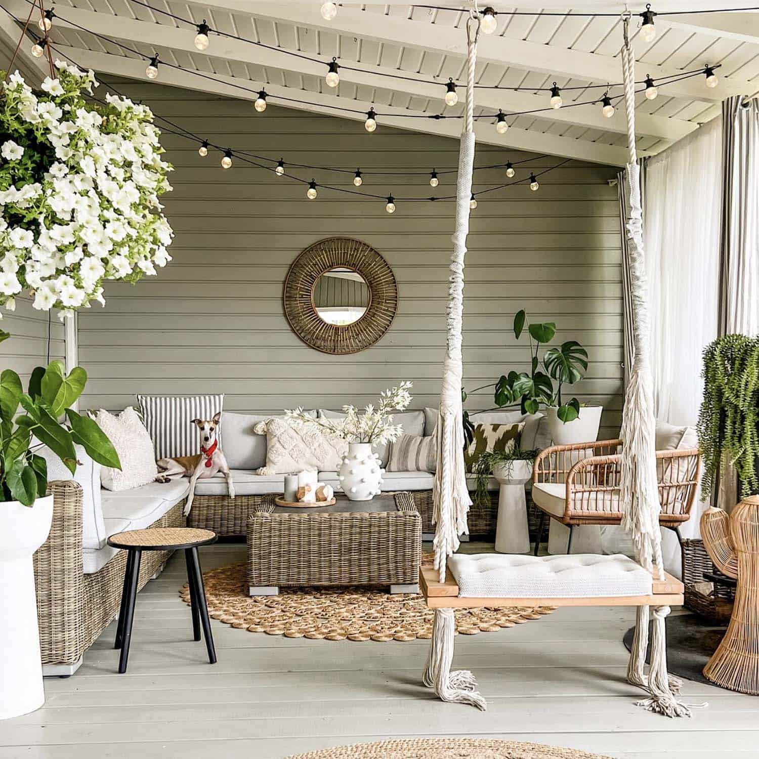 cozy covered patio with a wicker sectional and hanging swing
