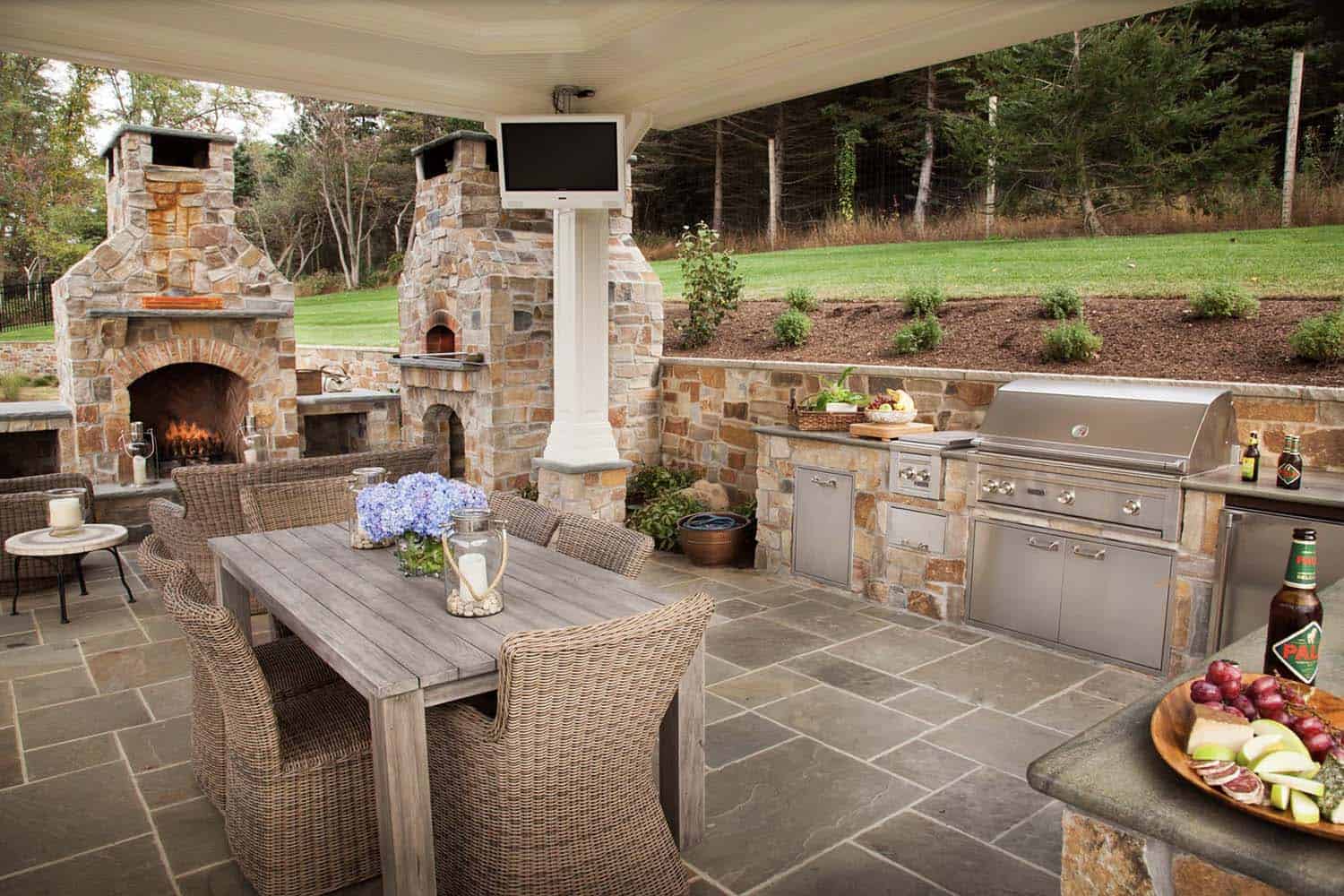 traditional covered patio with a grill, alfresco dining and fireplace