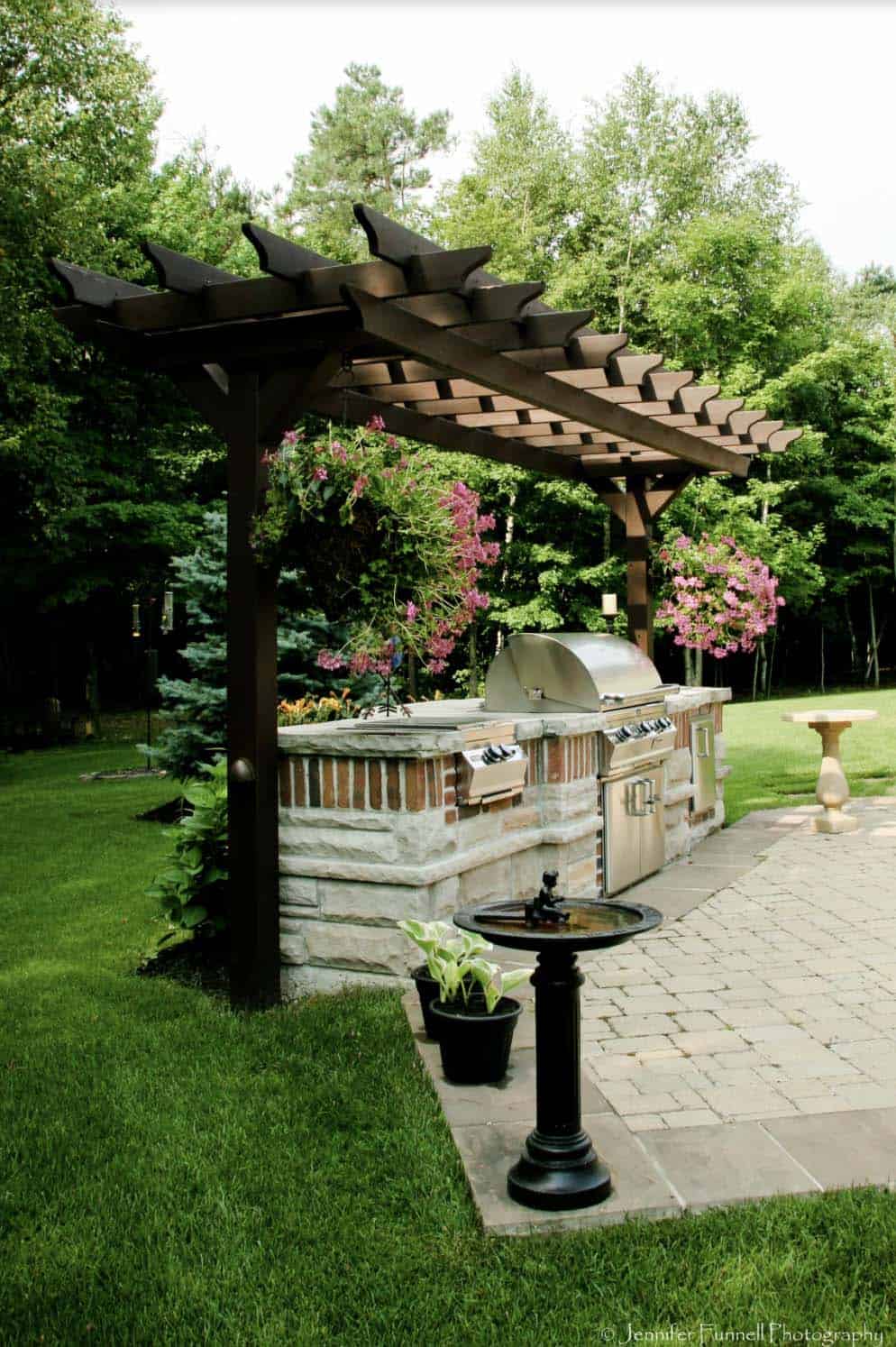 traditional patio with a pergola over the grilling station
