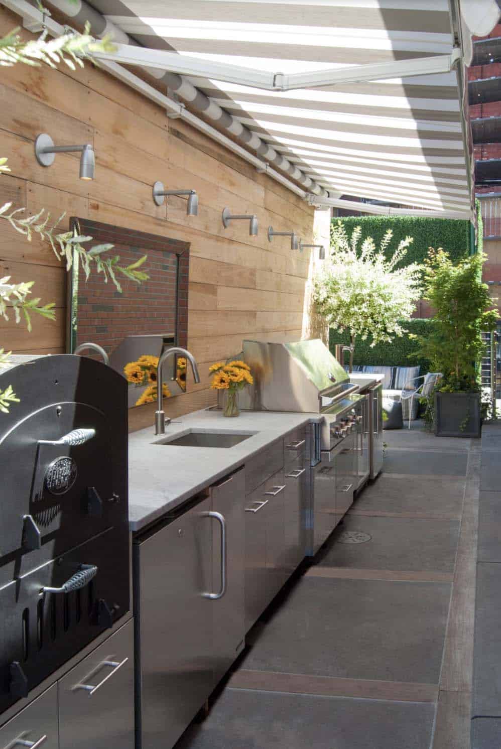 contemporary rooftop deck with a retractable awning and outdoor grilling station