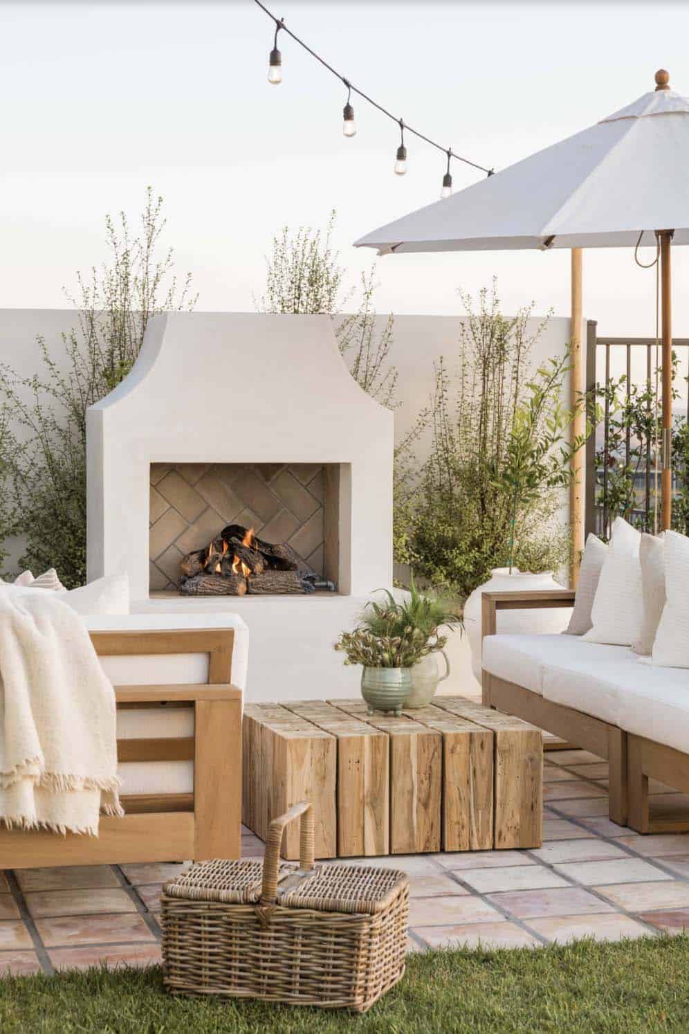beach style patio with a fireplace