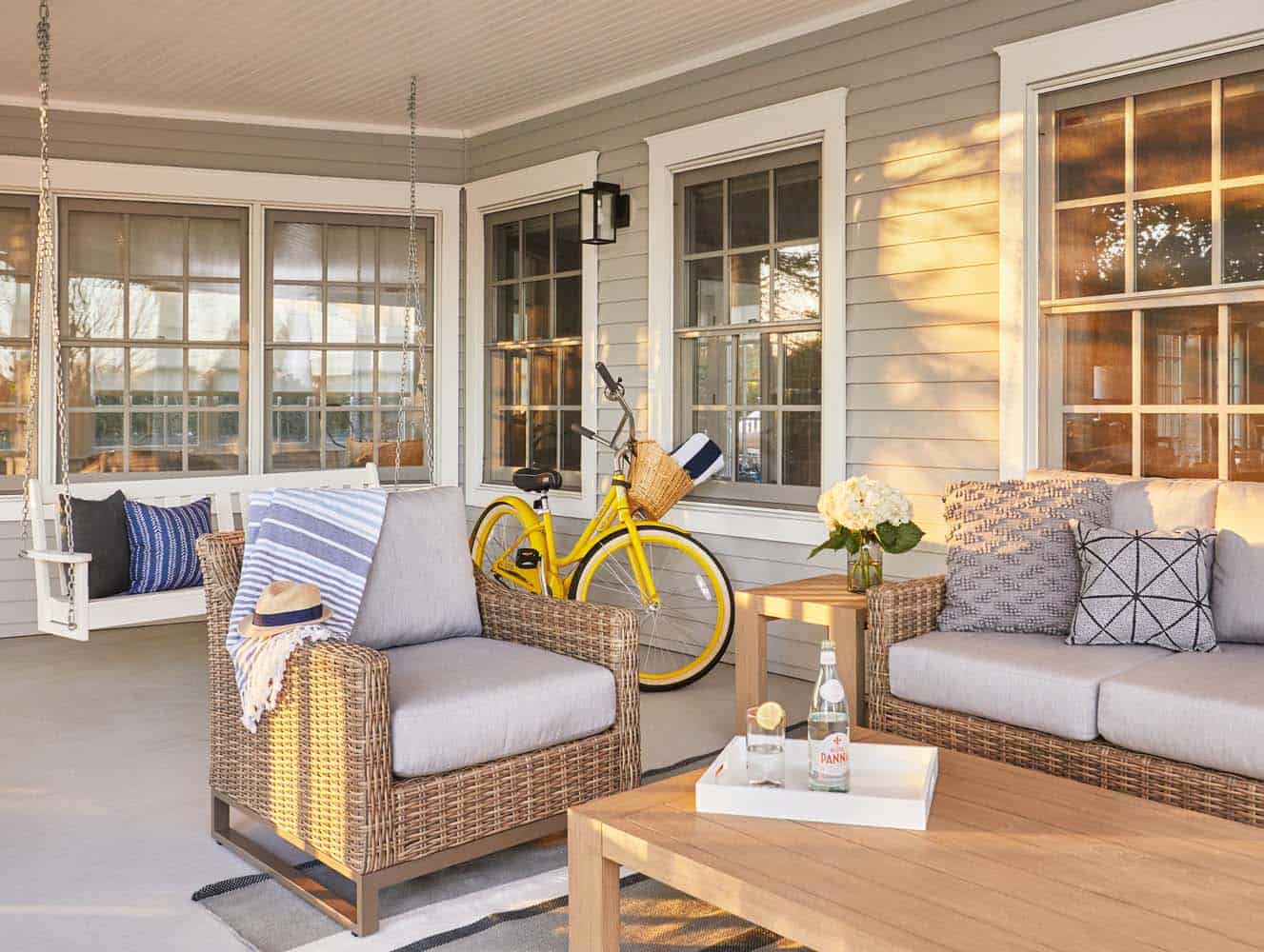 beach style covered patio with outdoor wicker furniture and a hanging swing