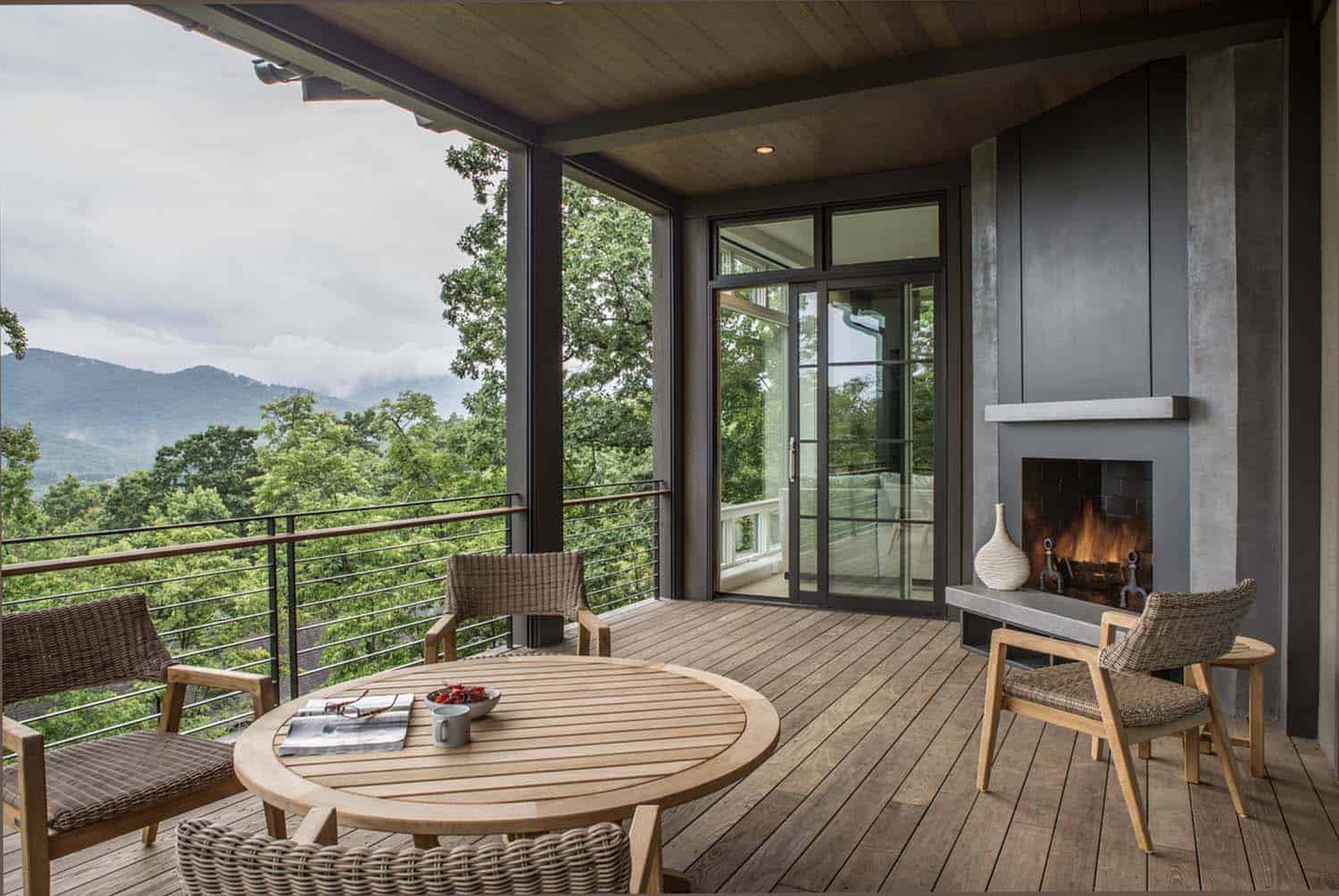 contemporary deck with a fireplace and mountain views