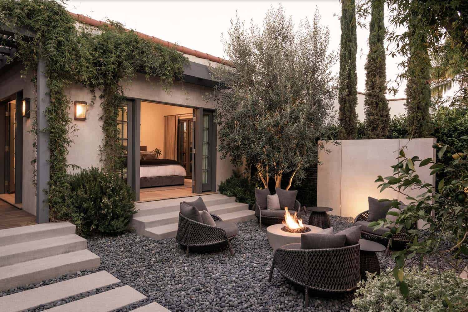urban retreat with a gravel patio, outdoor furniture and a fire pit