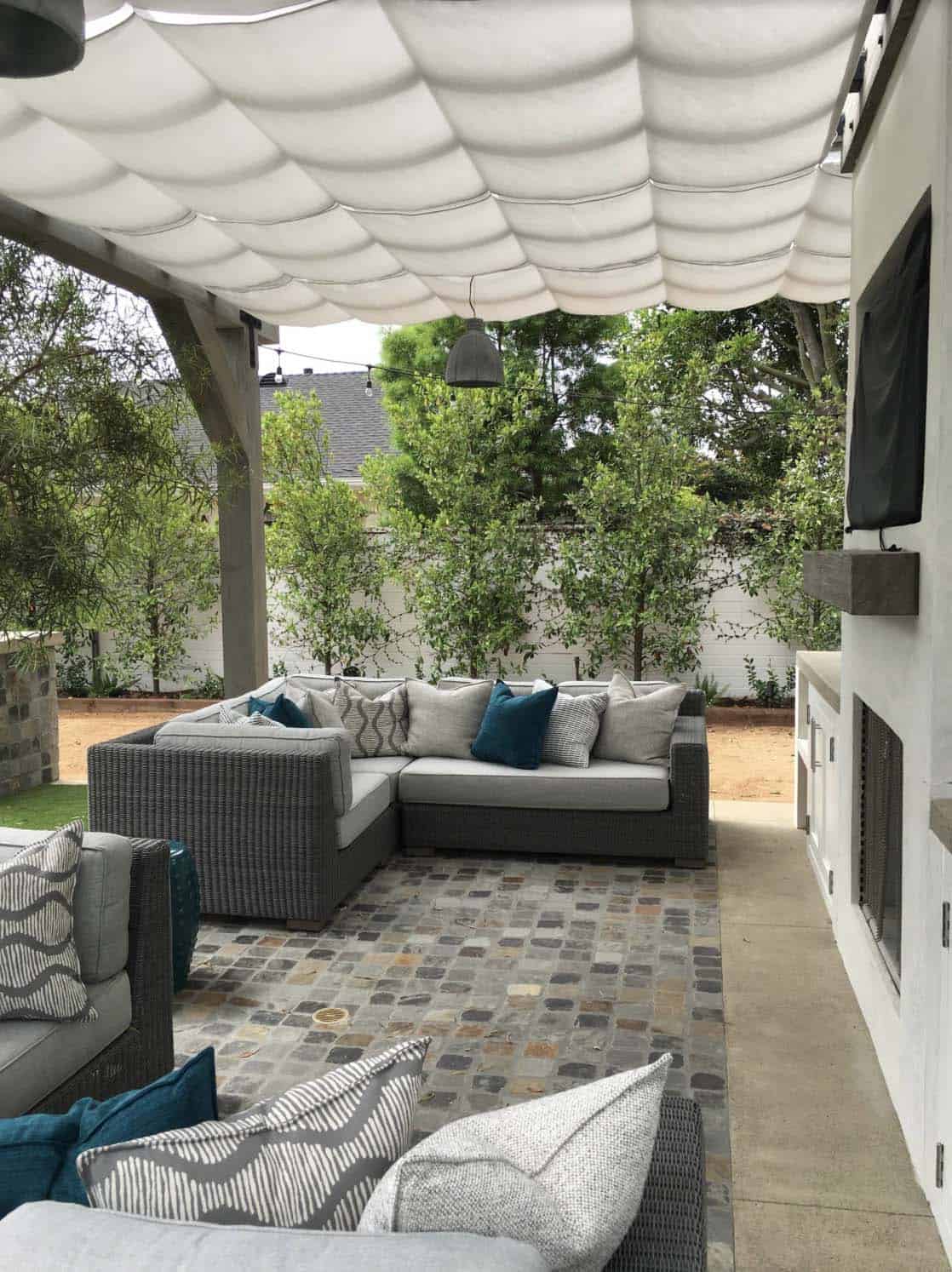 beach style patio with with a wood pergola and Sunbrella shading