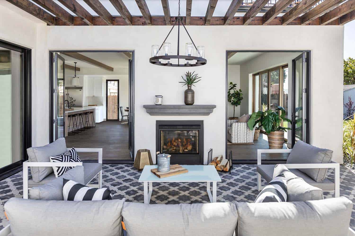 Mediterranean style patio with a fireplace and graphic patterned tile flooring