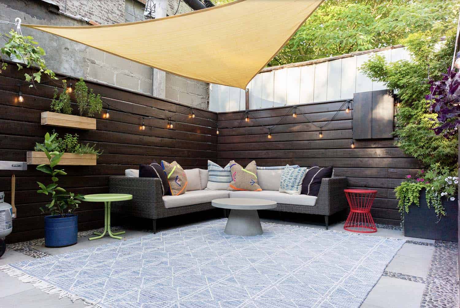eclectic backyard patio design with a sun sail