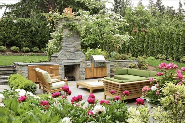 traditional backyard patio with a fireplace and outdoor furniture