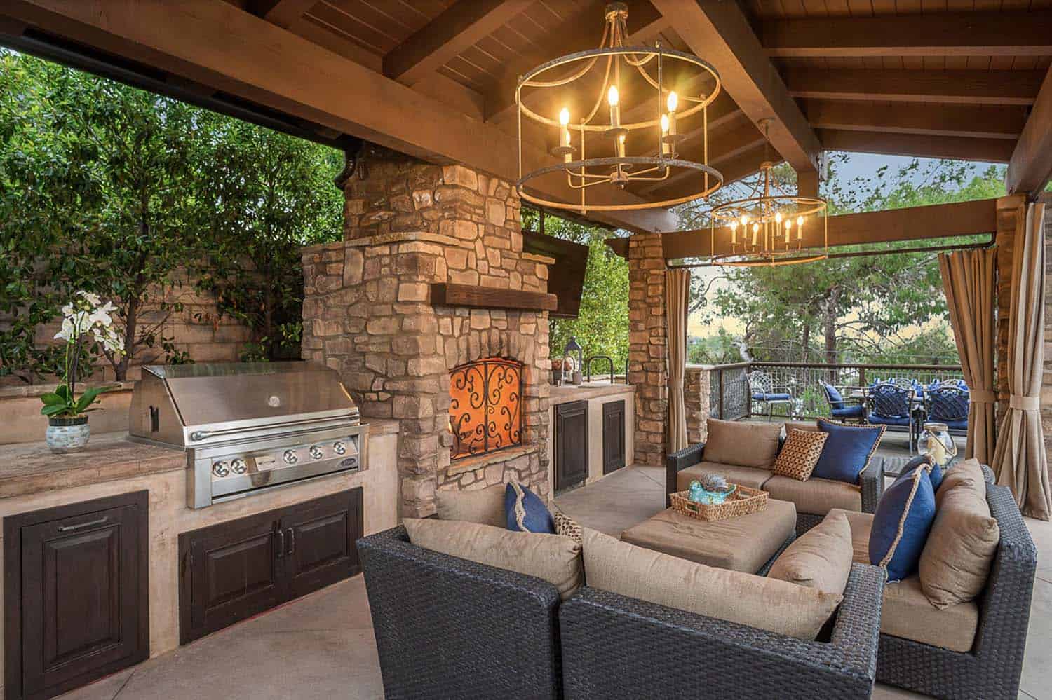 Mediterranean outdoor patio with a fireplace and furniture