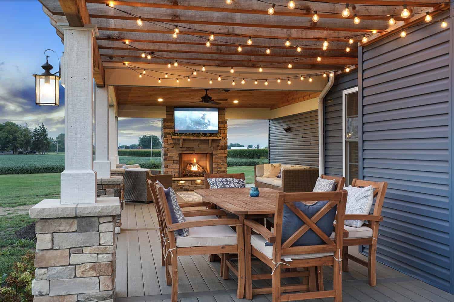 outdoor pergola with dining and living space and string lights